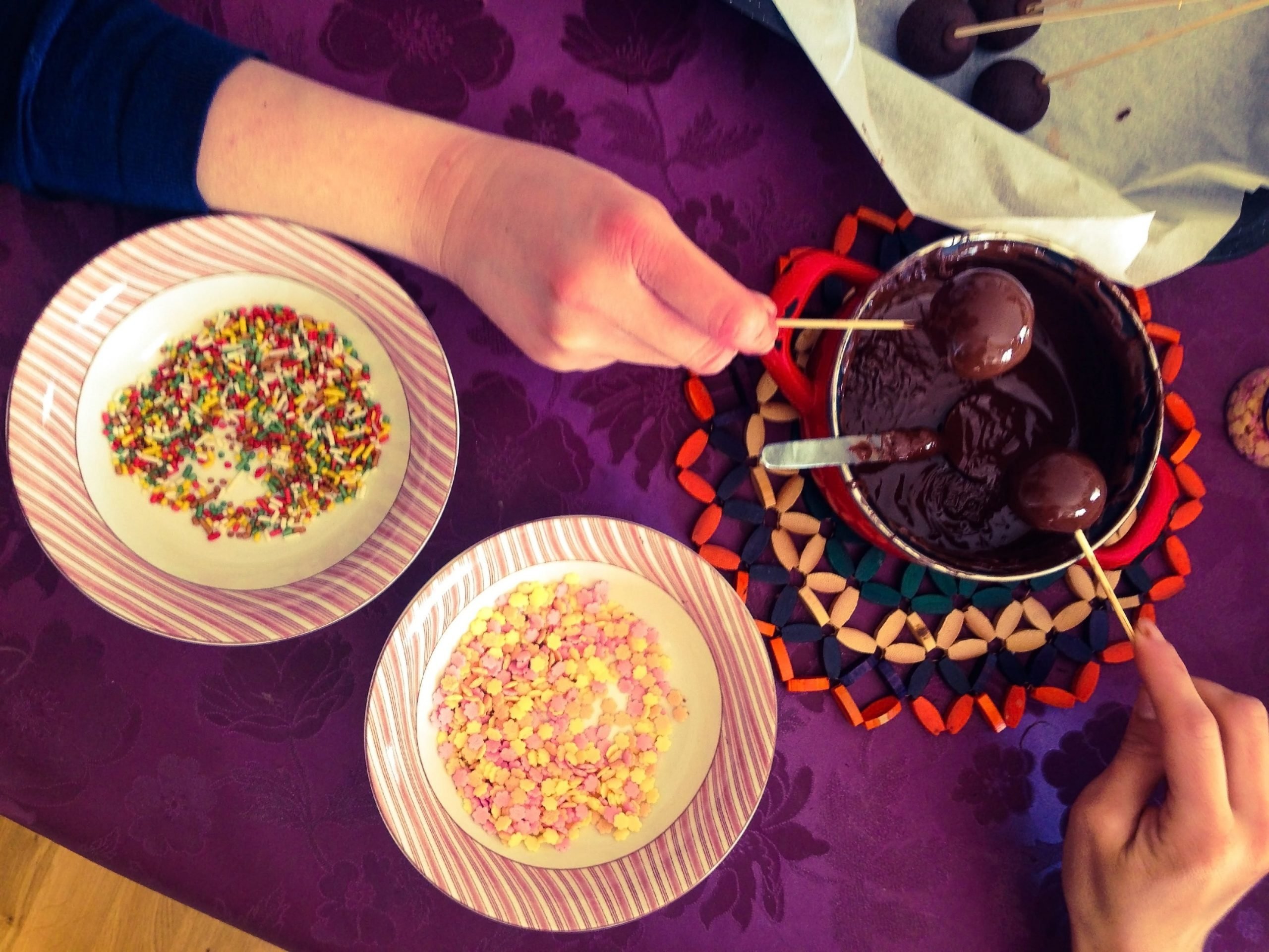 Two people preparing cake pops.