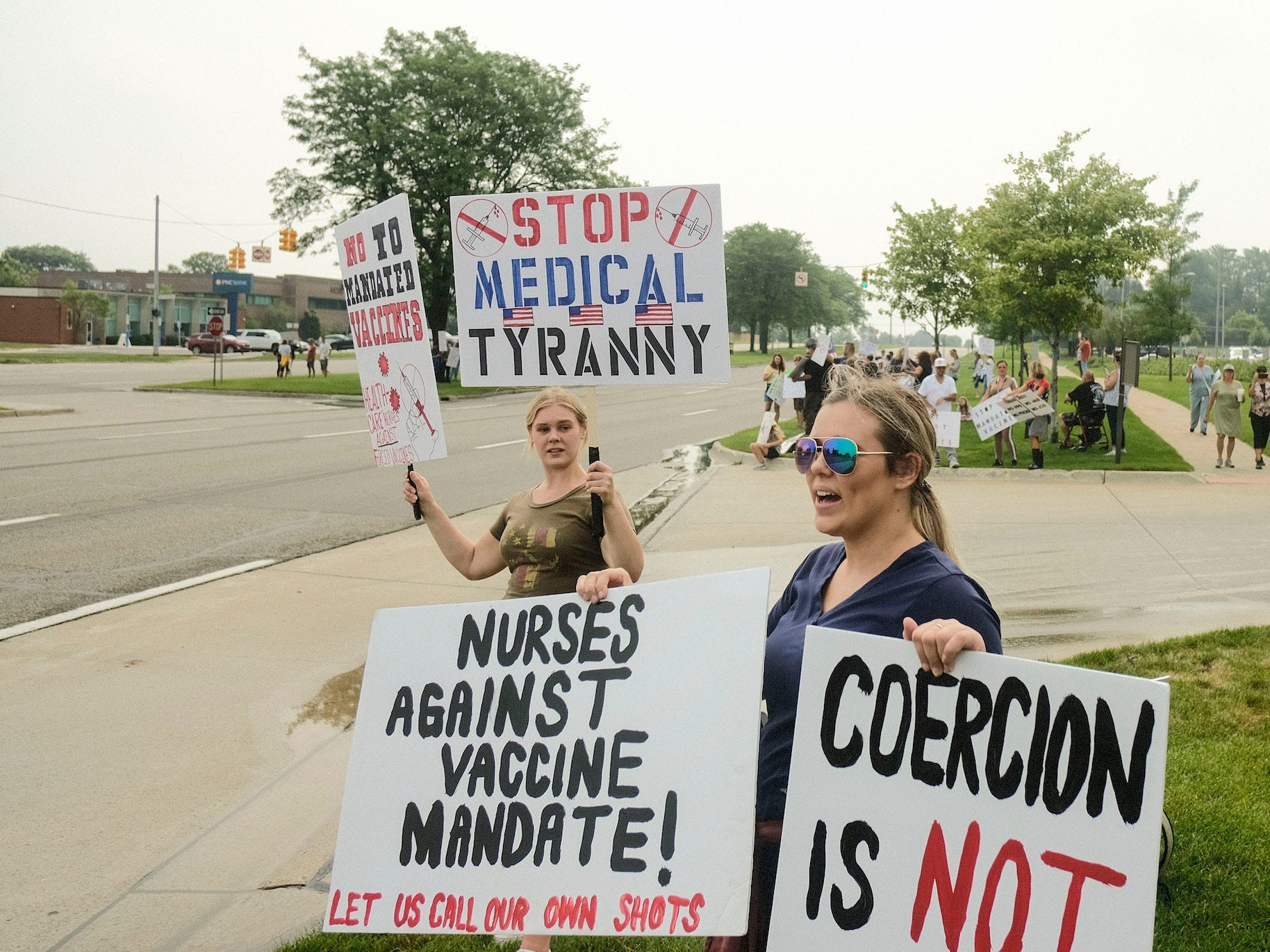 Protesters holding placards expressing their opinion while chanting outside St. Joseph Mercy Oakland Hospital, during the demonstration. Health care workers and others gathered at several hospitals throughout Michigan protesting the recent announcement by Trinity Health and Henry Ford Health systems that requires nurses and other health workers under their employment to receive the Coronavirus Vaccine on July 24 2021.