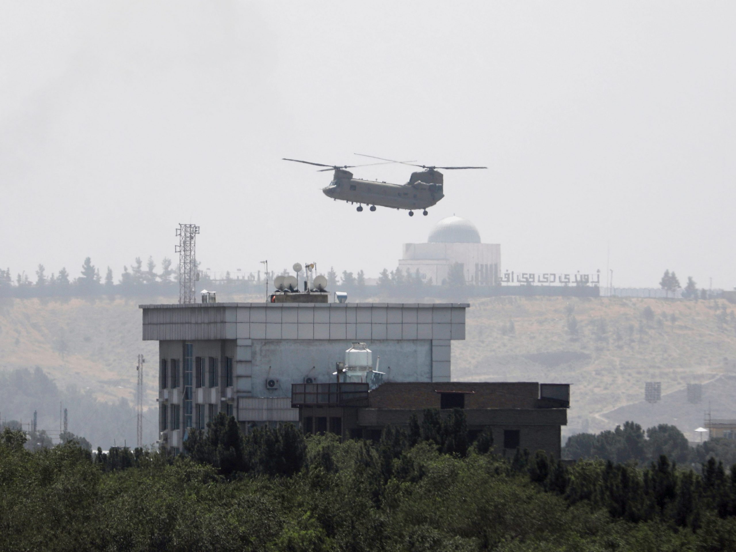 A U.S. Chinook helicopter flies near the U.S. Embassy in Kabul, Afghanistan, Sunday, Aug. 15, 2021.