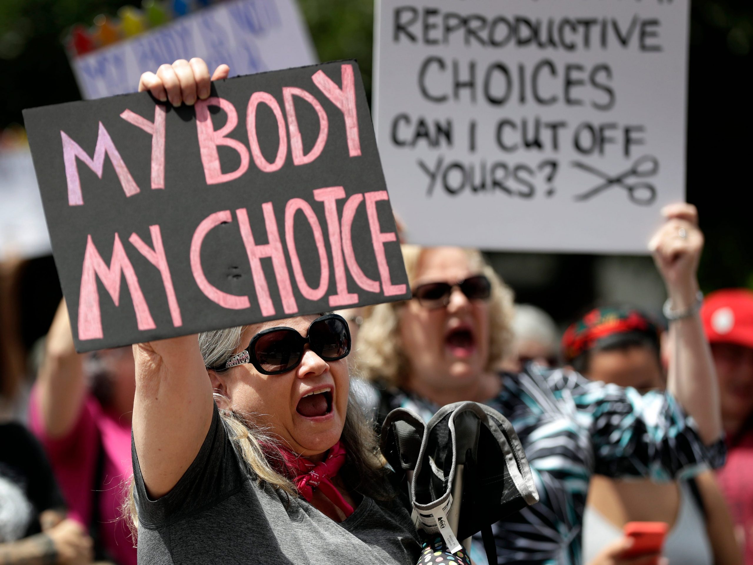 Protesters hold signs at an abortion rally at the Texas State Capitol in 2019.