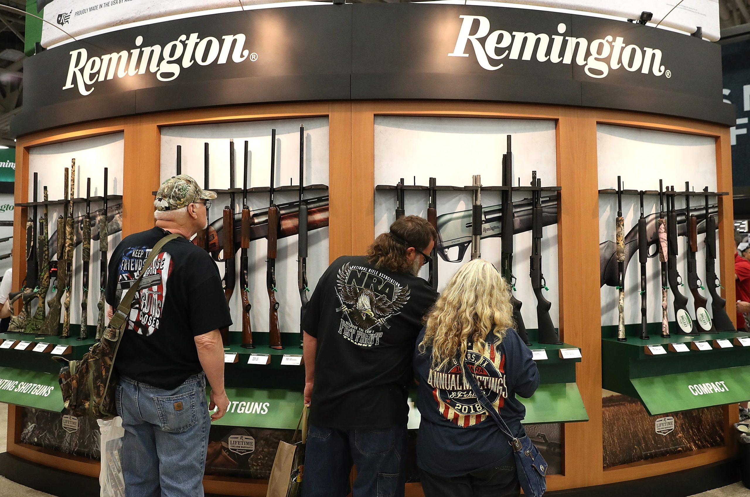 Attendees look at a display of Remington shotguns during the NRA Annual Meeting & Exhibits at the Kay Bailey Hutchison Convention Center on May 5, 2018 in Dallas, Texas