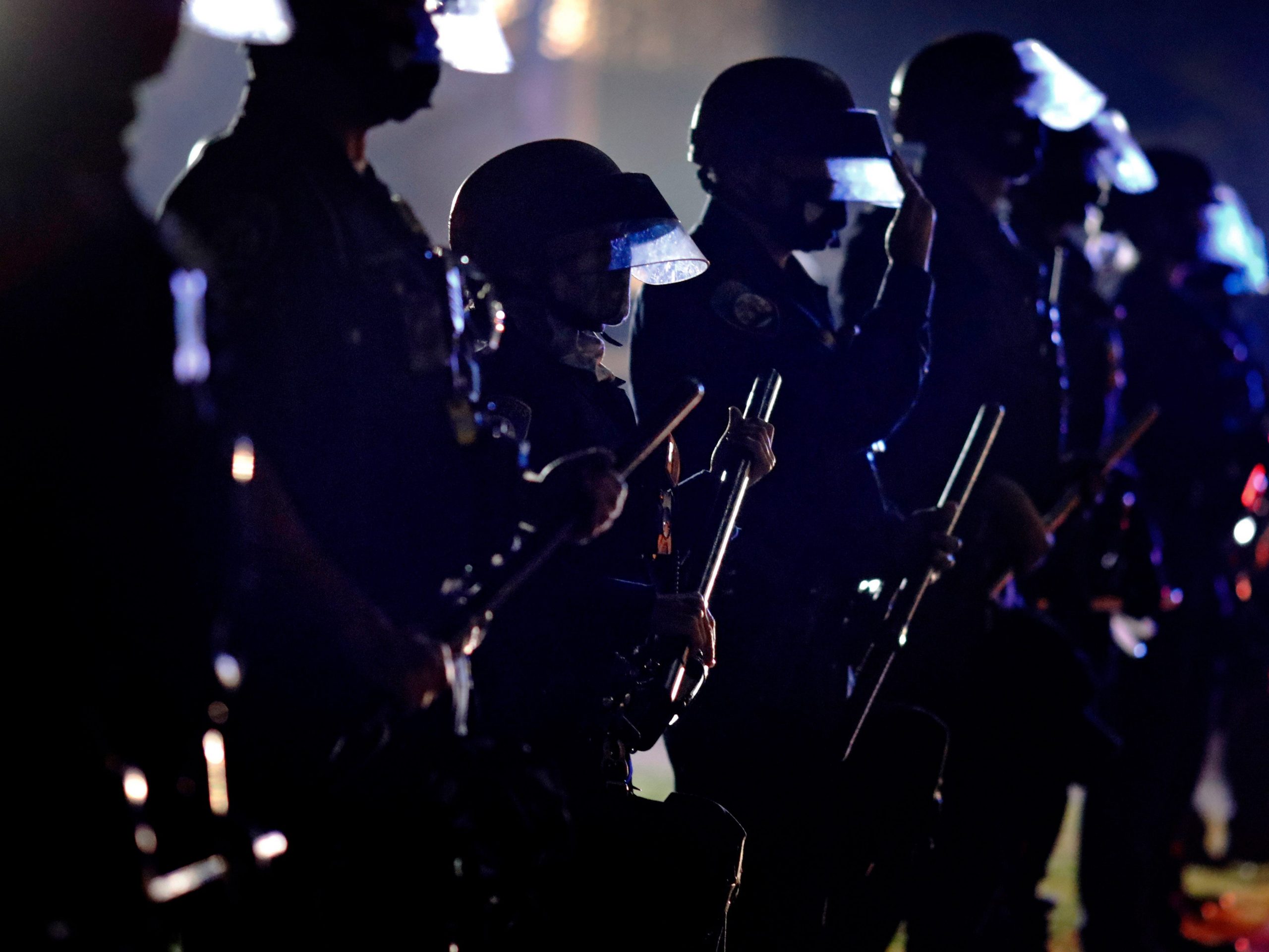 In this Tuesday, Nov. 3, 2020 file photo, police hold their clubs as they form a line in front of supporters of President Donald Trump on Election Day in Beverly Hills, Calif.