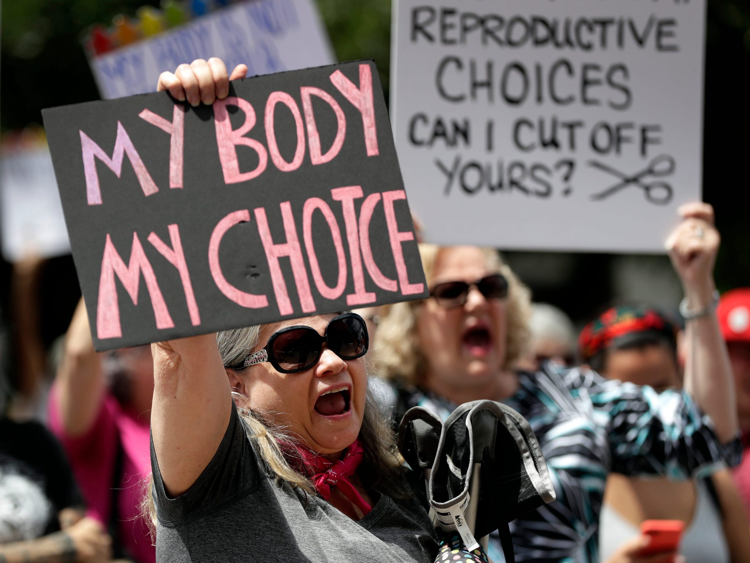 Protesters hold signs at an abortion rally at the Texas State Capitol in 2019.