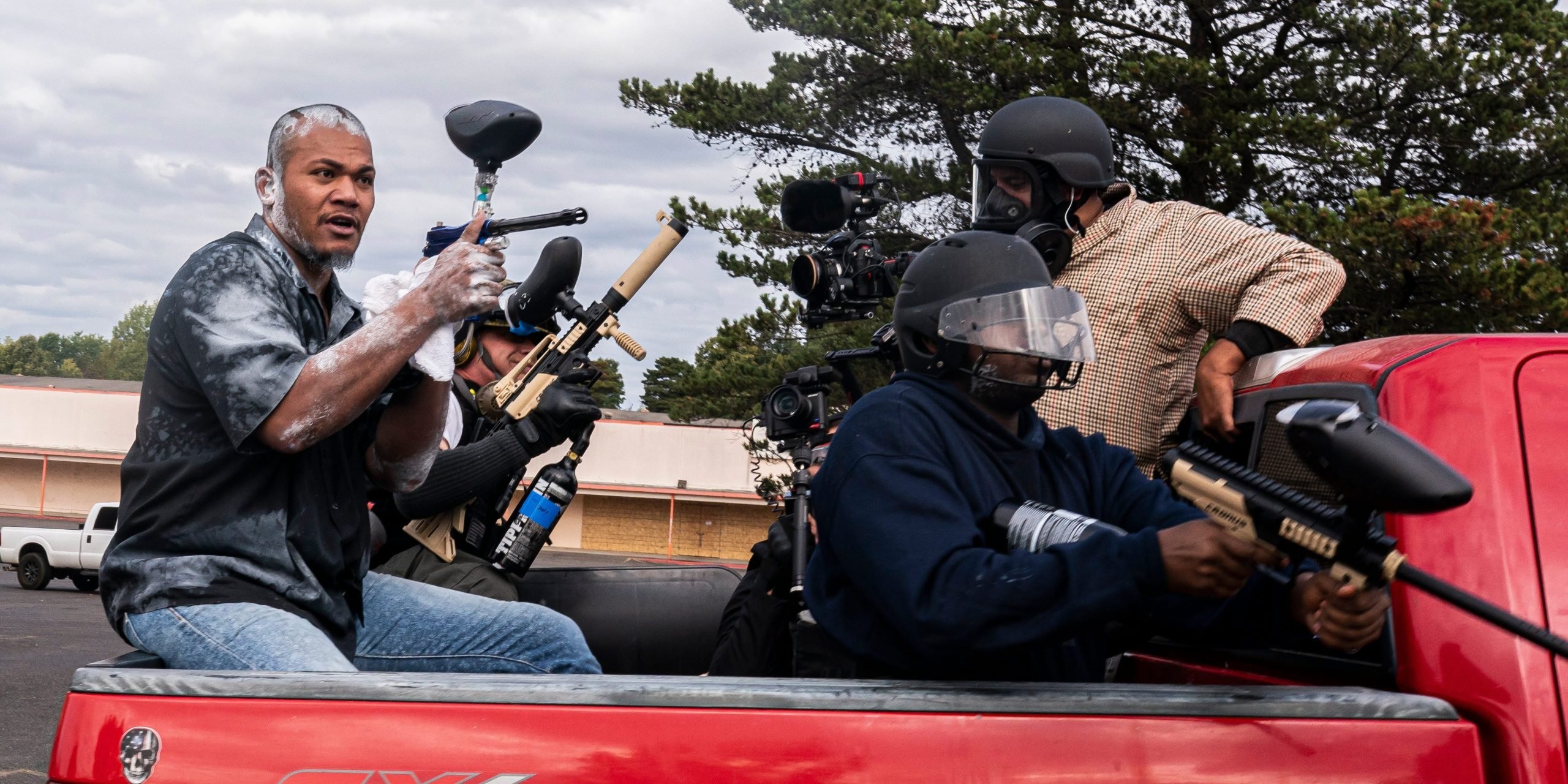 Member of far-right group Proud Boys Tusitala "Tiny" Toese (L) aims a paintball gun at far-left counter protesters on August 22, 2021 in Portland, Oregon.