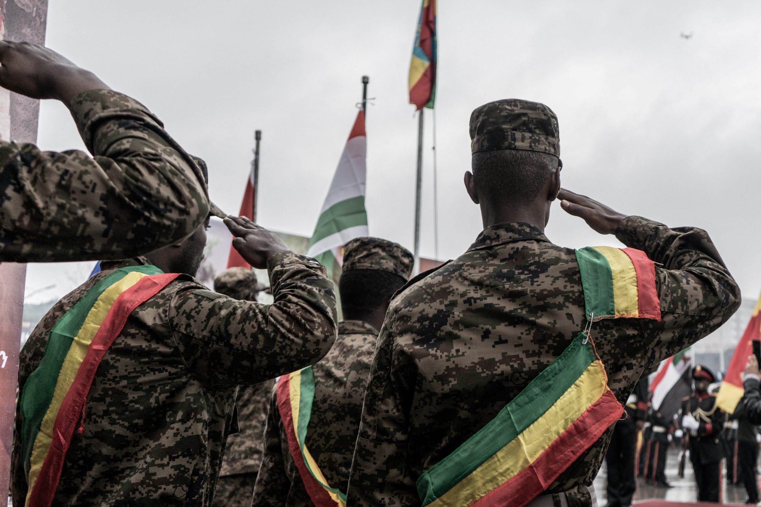 Members of Ethiopian military force stand to attention for the Ethiopian national anthem during a farewell ceremony for new recruits joining the Ethiopian military force to Tigray, organised by the Mayor in Addis Ababa on July 27, 2021.