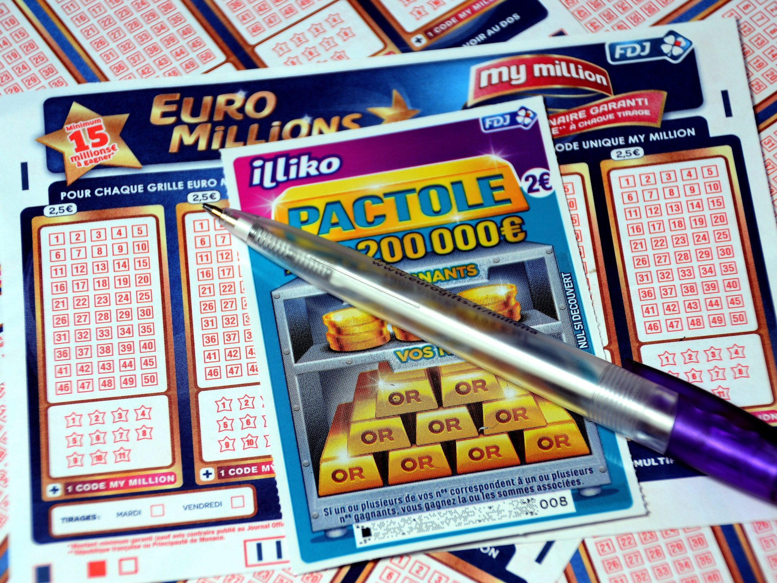 In this photo illustration is a pen and a scratch card on Euromillions tickets.