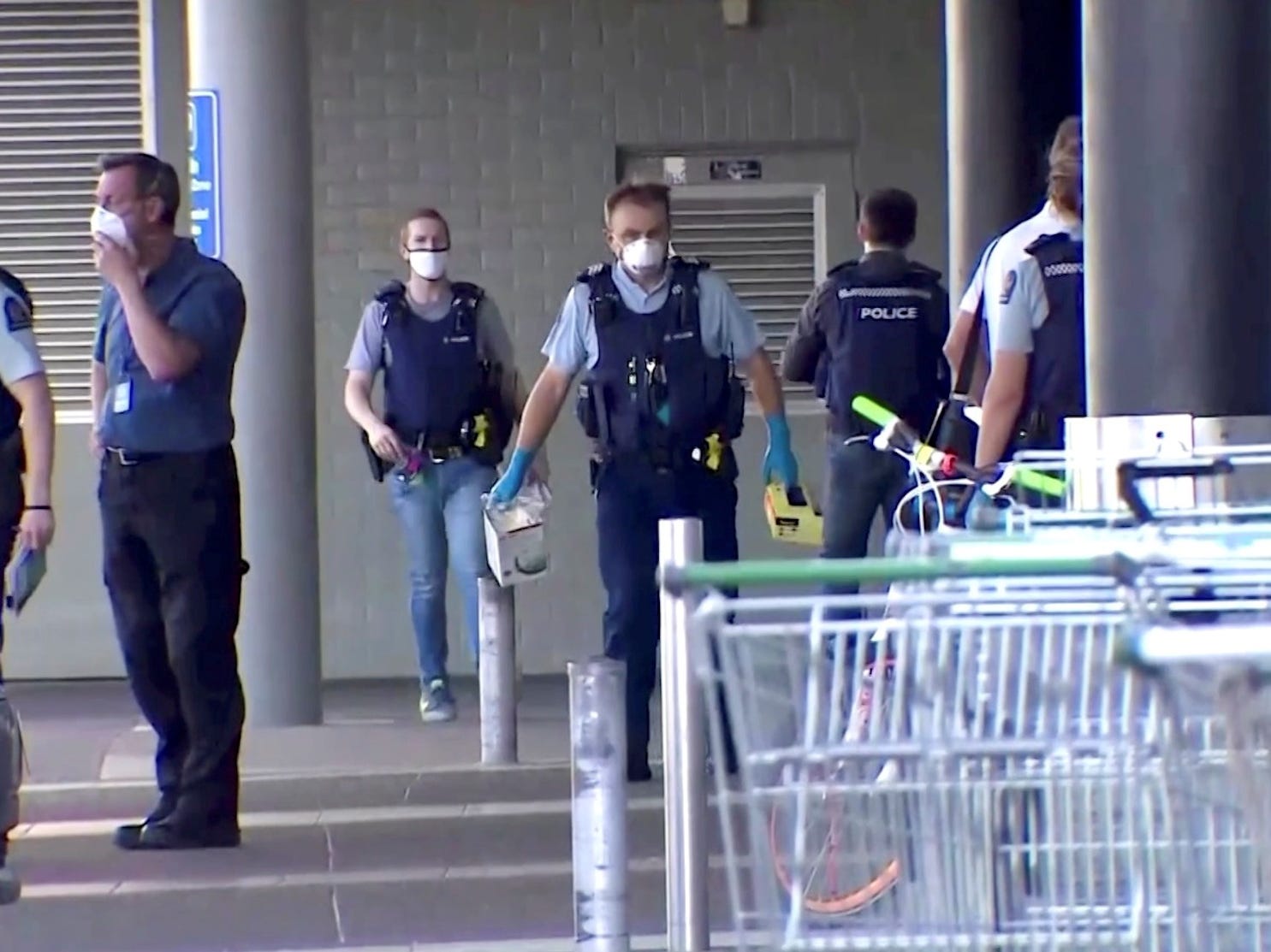 Police outside a building and shopping carts