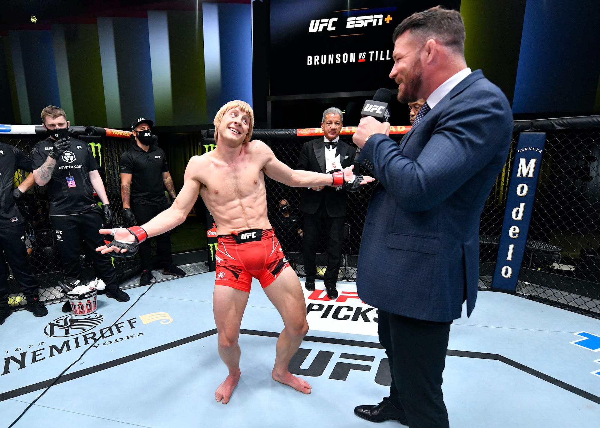 Paddy Pimblett gestures to UFC commentator and former champ Michael Bisping after his debut win for the promotion.
