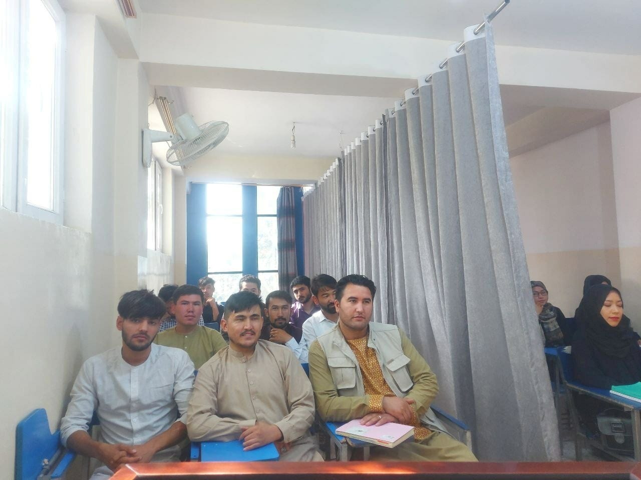 Students attend class under new classroom conditions at Avicenna University in Kabul, Afghanistan, on September 6, 2021, in this picture obtained by Reuters from social media.