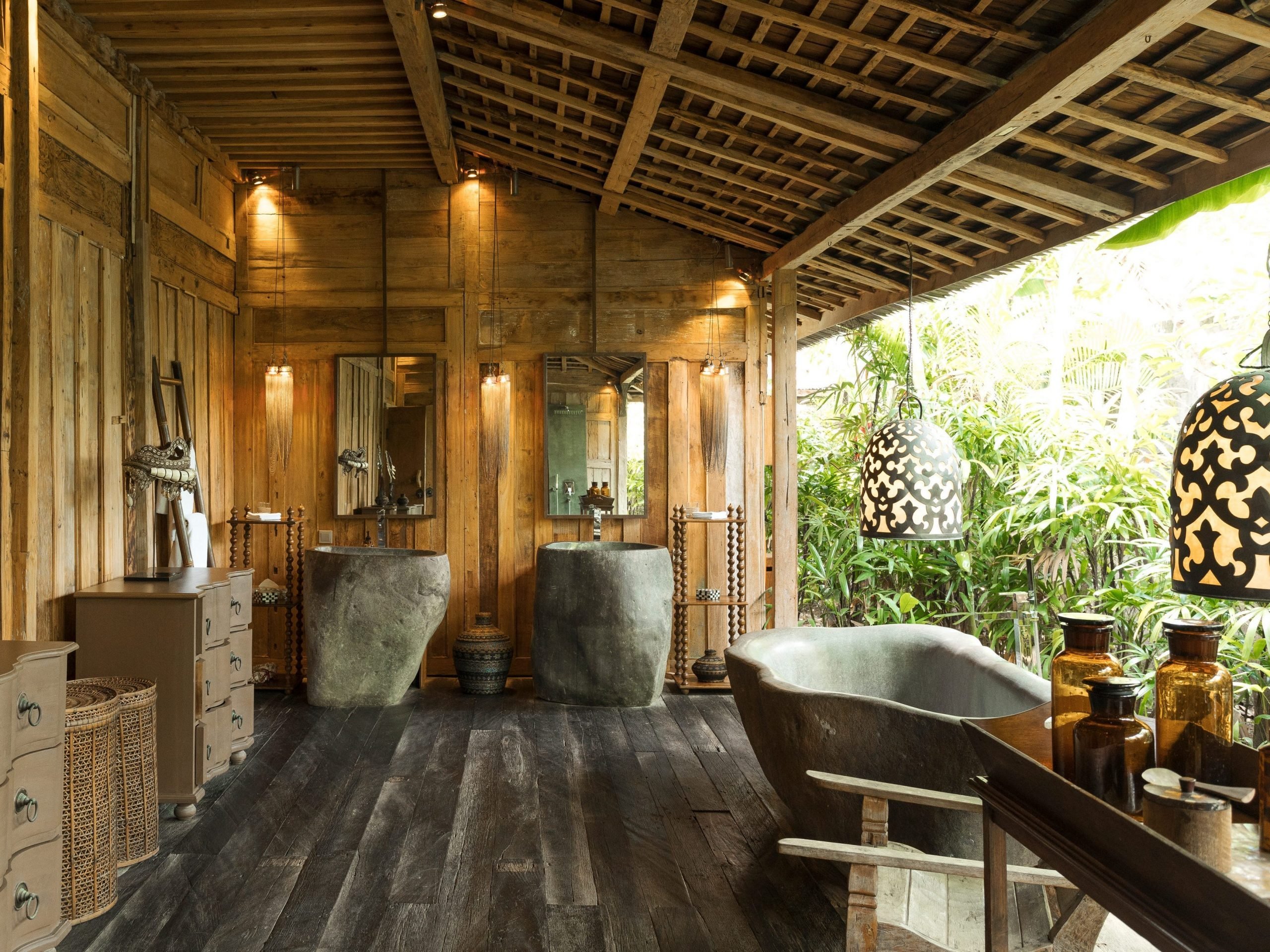 the bathrooms open up to the outdoors and include free standing tubs and natural wood accents
