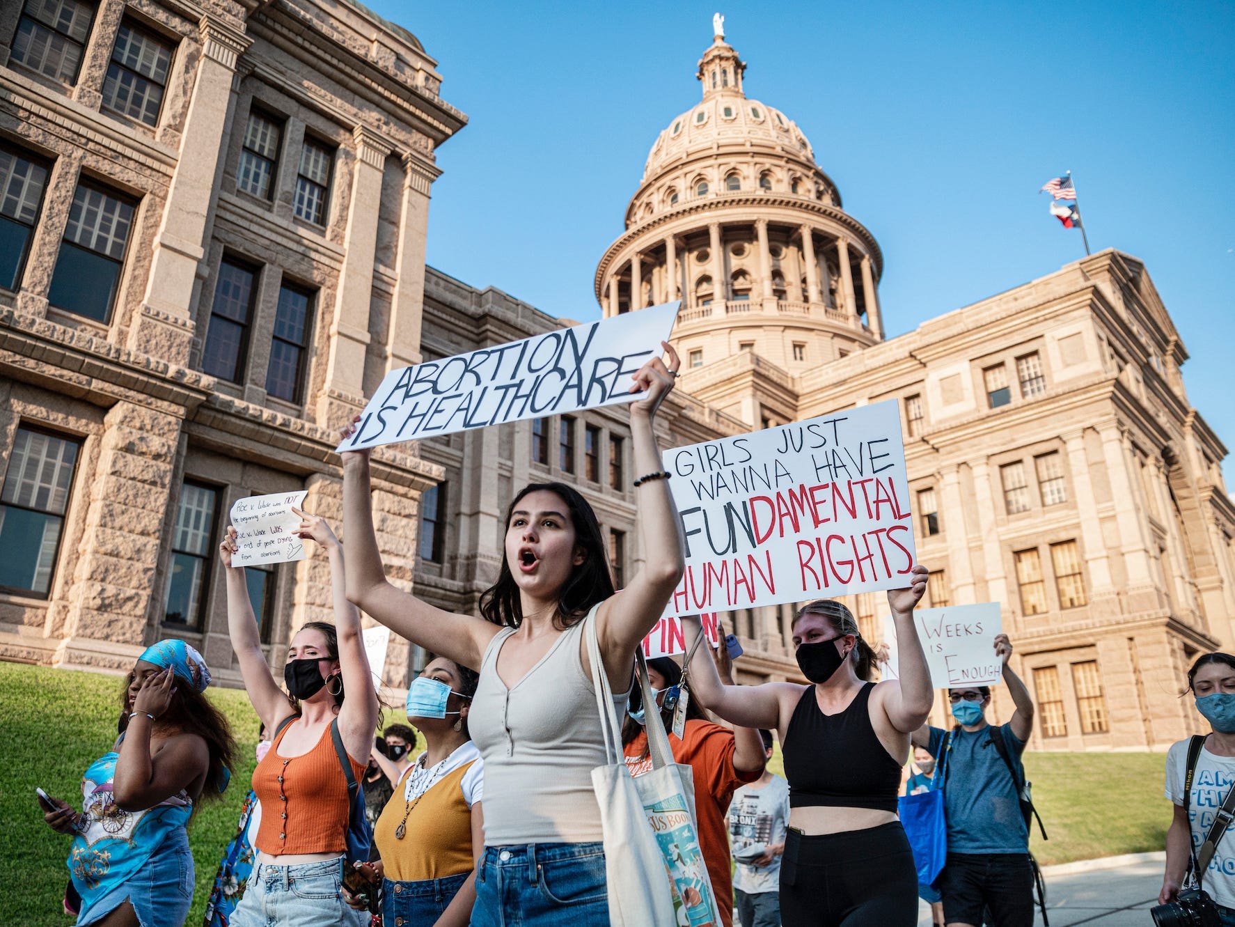Pro-choice protesters hold signs outside the Texas State Capitol