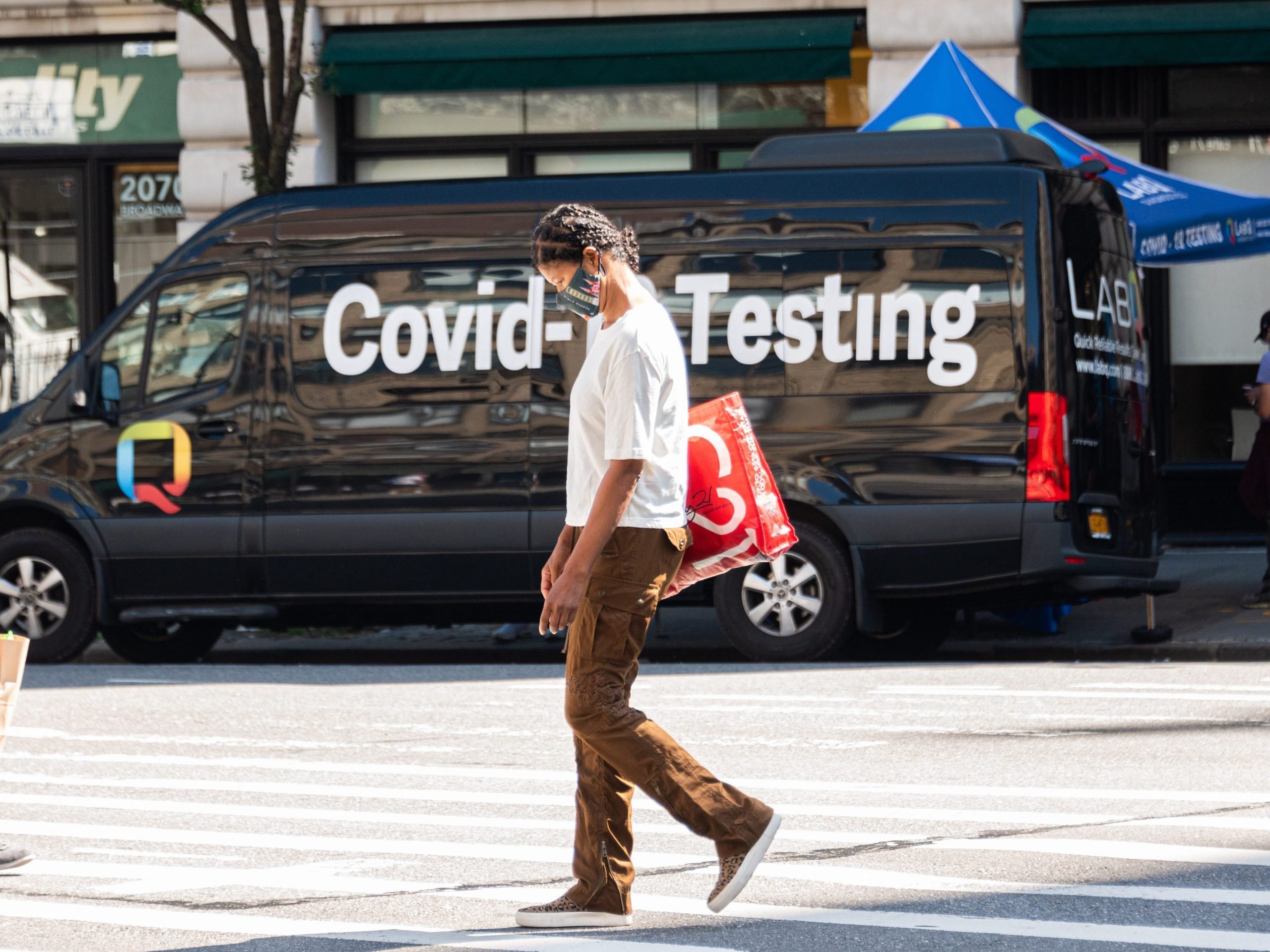 A person walks by a LabQ Covid-19 testing van on the Upper West Side over Labor Day Weekend on September 06, 2021 in New York City.