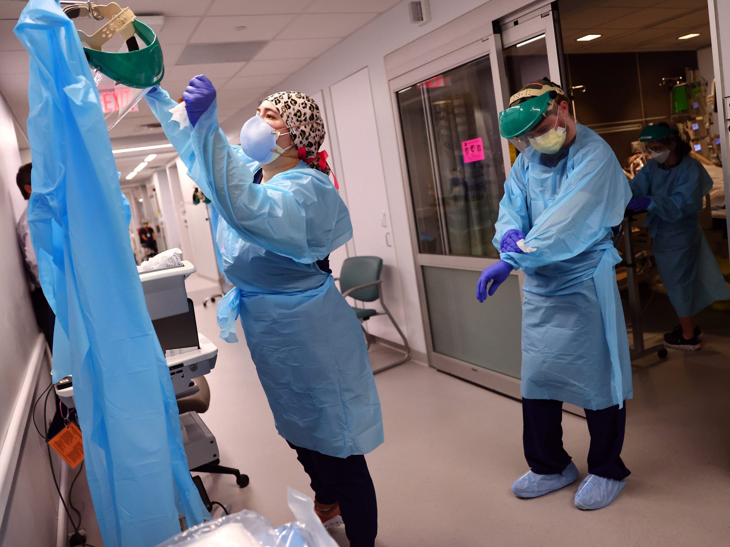 Clinicians depart a patient room after re-positioning a COVID-19 patient into the supine position in the Intensive Care Unit (ICU) at Lake Charles Memorial Hospital on August 10, 2021 in Lake Charles, Louisiana.