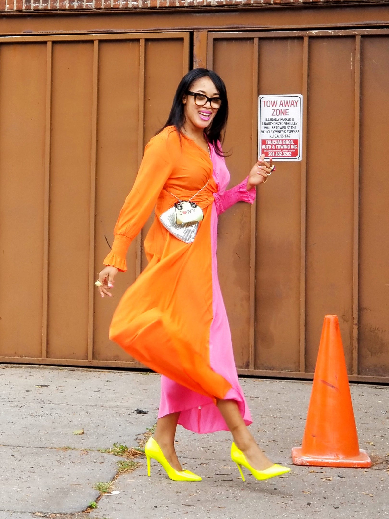 celebrity stylist wearing a bright orange and pink dress with yellow heels