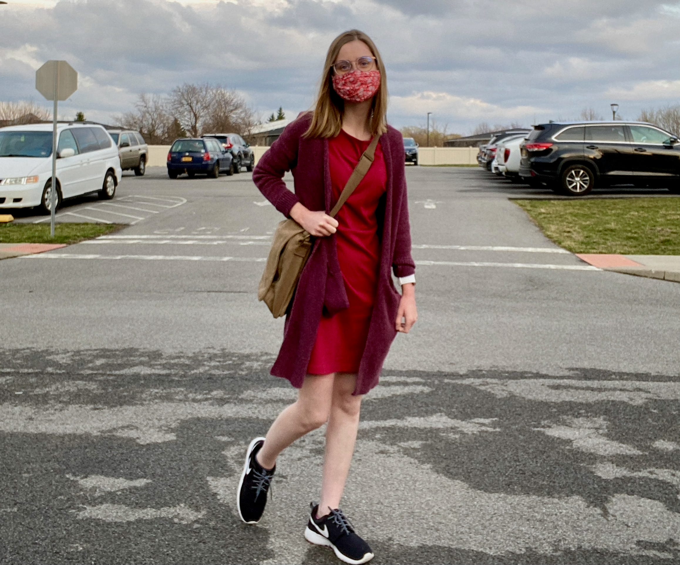Emyle Watkins in a red dress and mask.