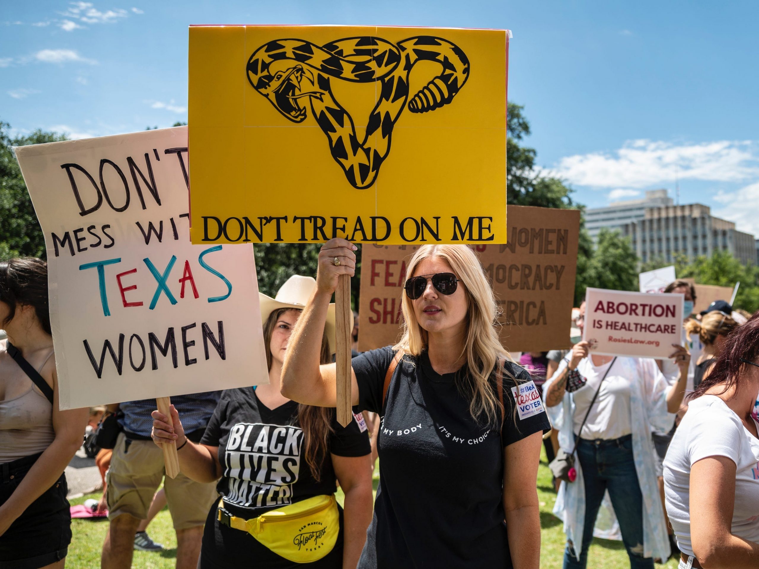 Protesters hold up signs at a protest against Texas' new abortion law outside the state capitol on May 29, 2021 in Austin, Texas.