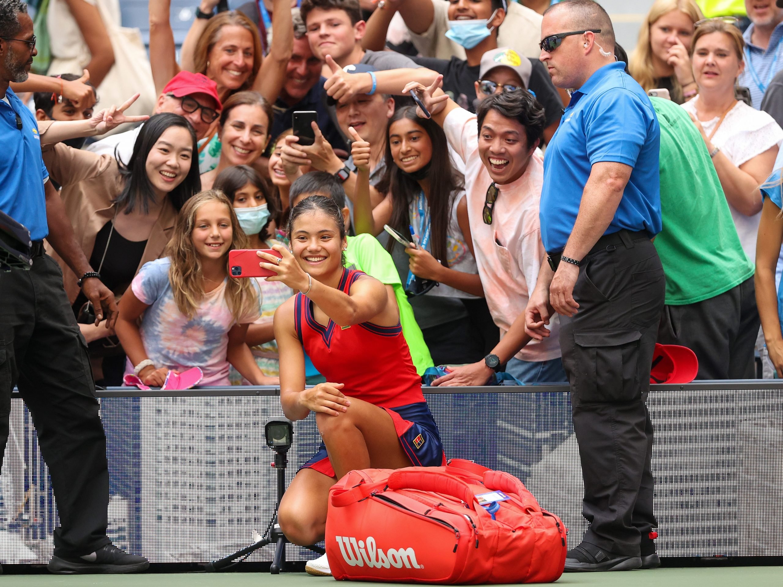 Emma Raducanu posing with fans at the US Open