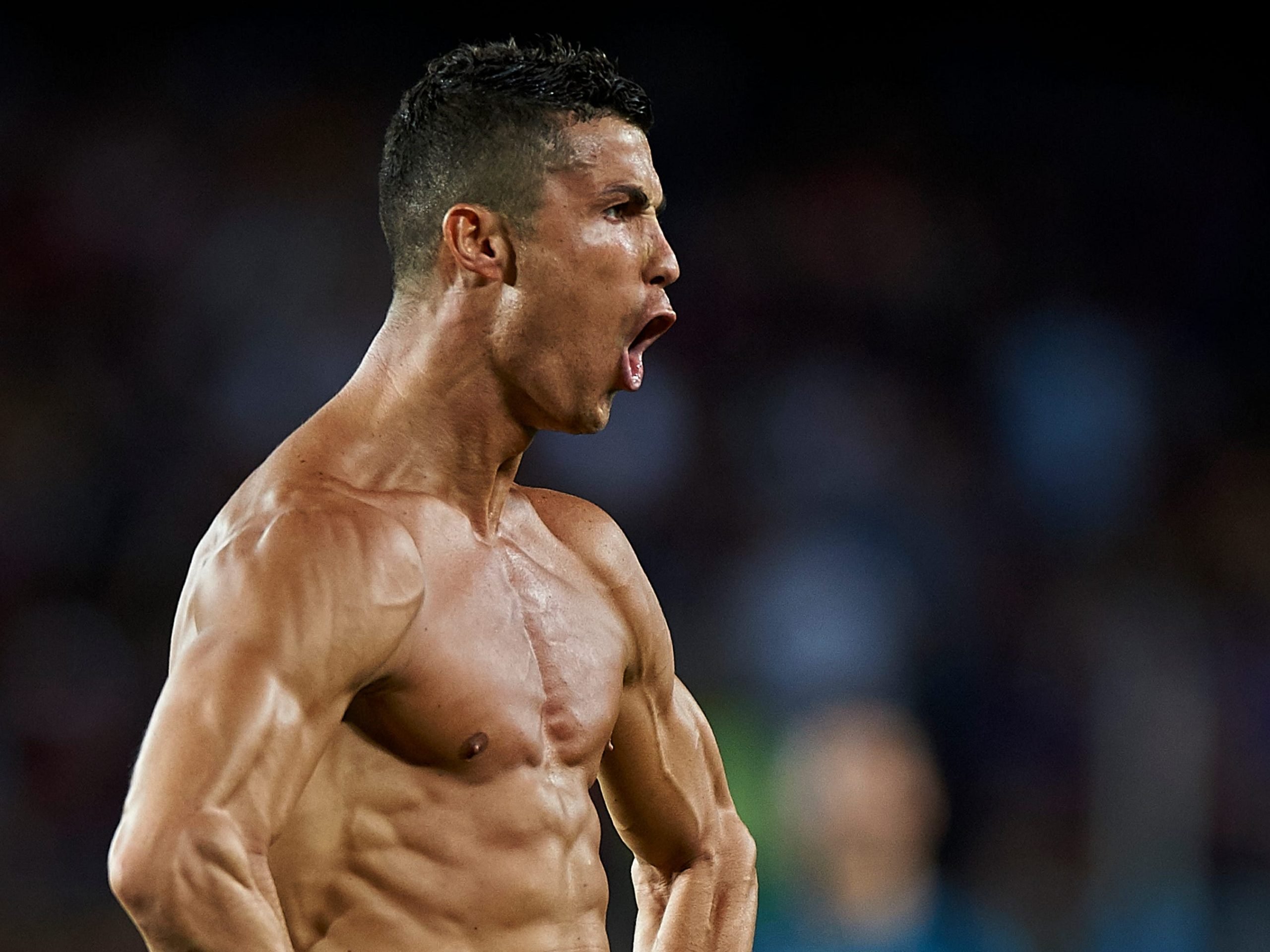 Cristiano Ronaldo celebrates by taking his shirt off