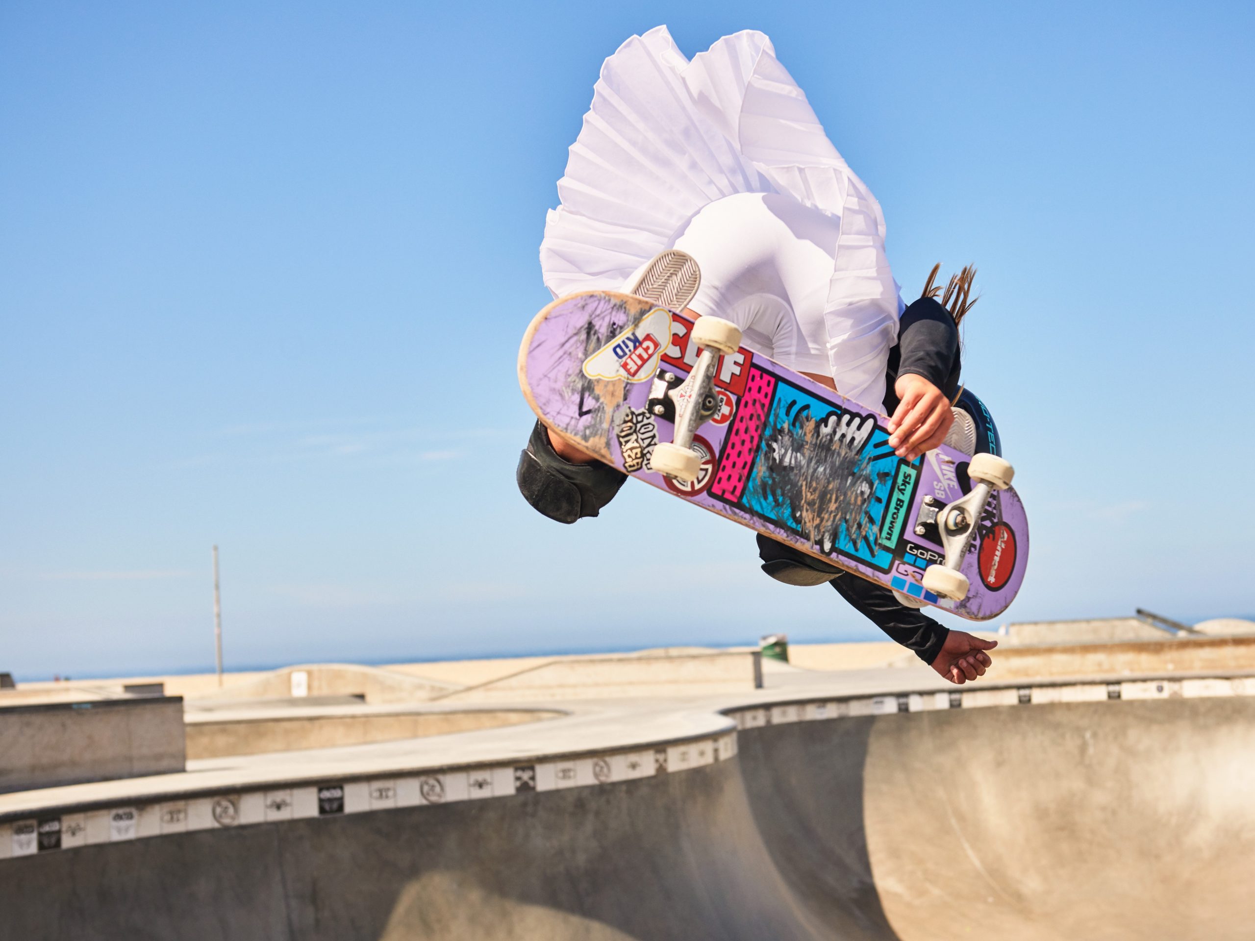 Sky Brown gets air in a bowl with blue skies in the background