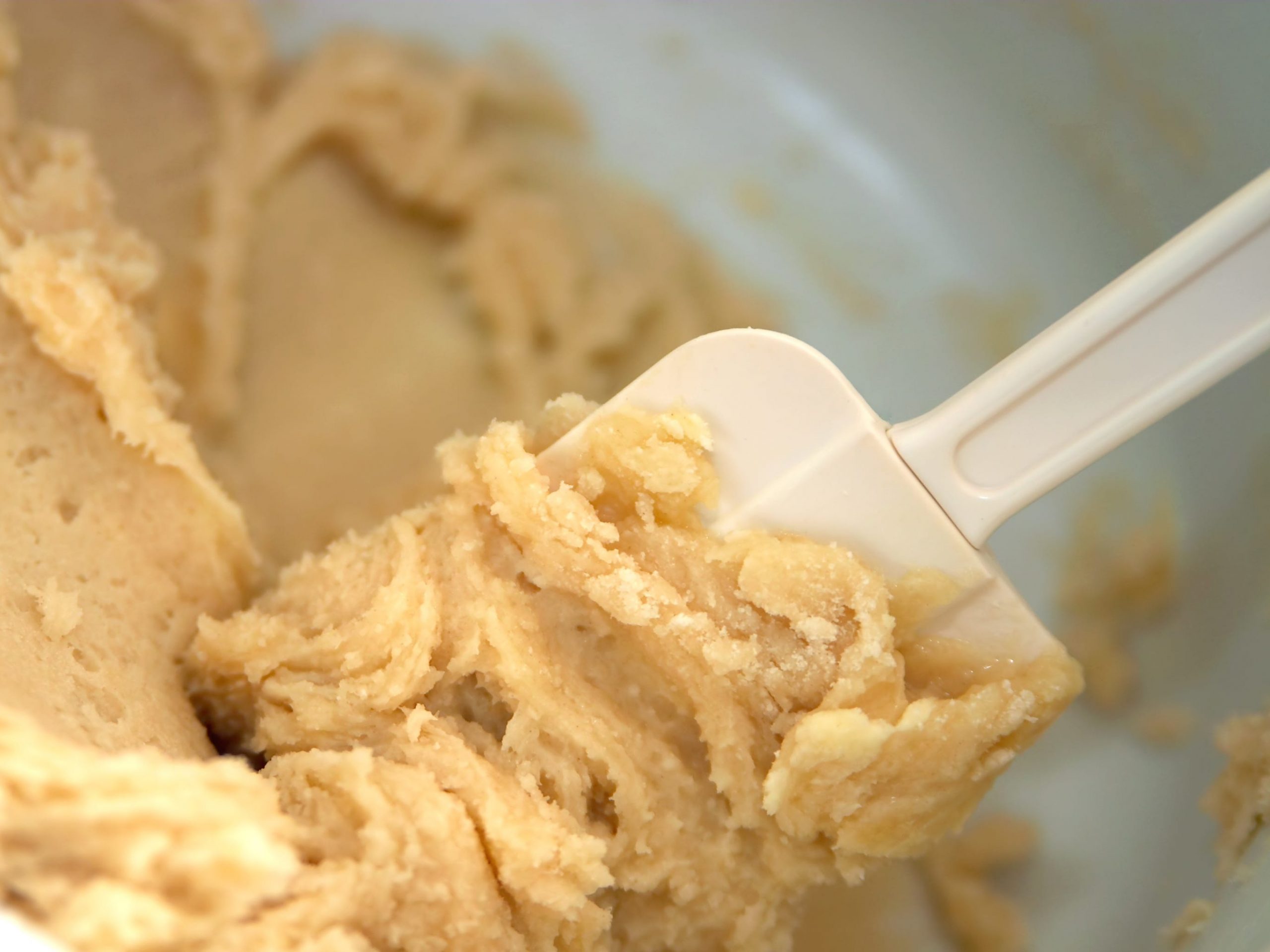 A spatula mixing cookie dough.