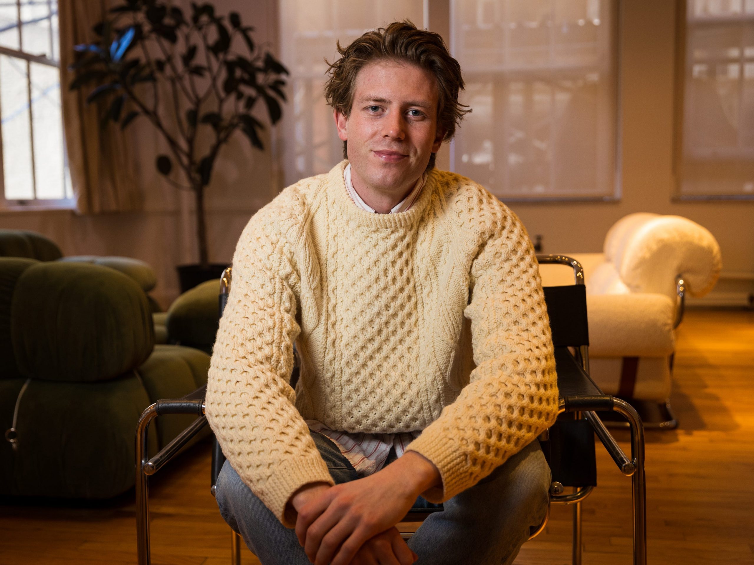 James Cadwallader, cofounder and CCO of Kyra, sits with arms crossed.
