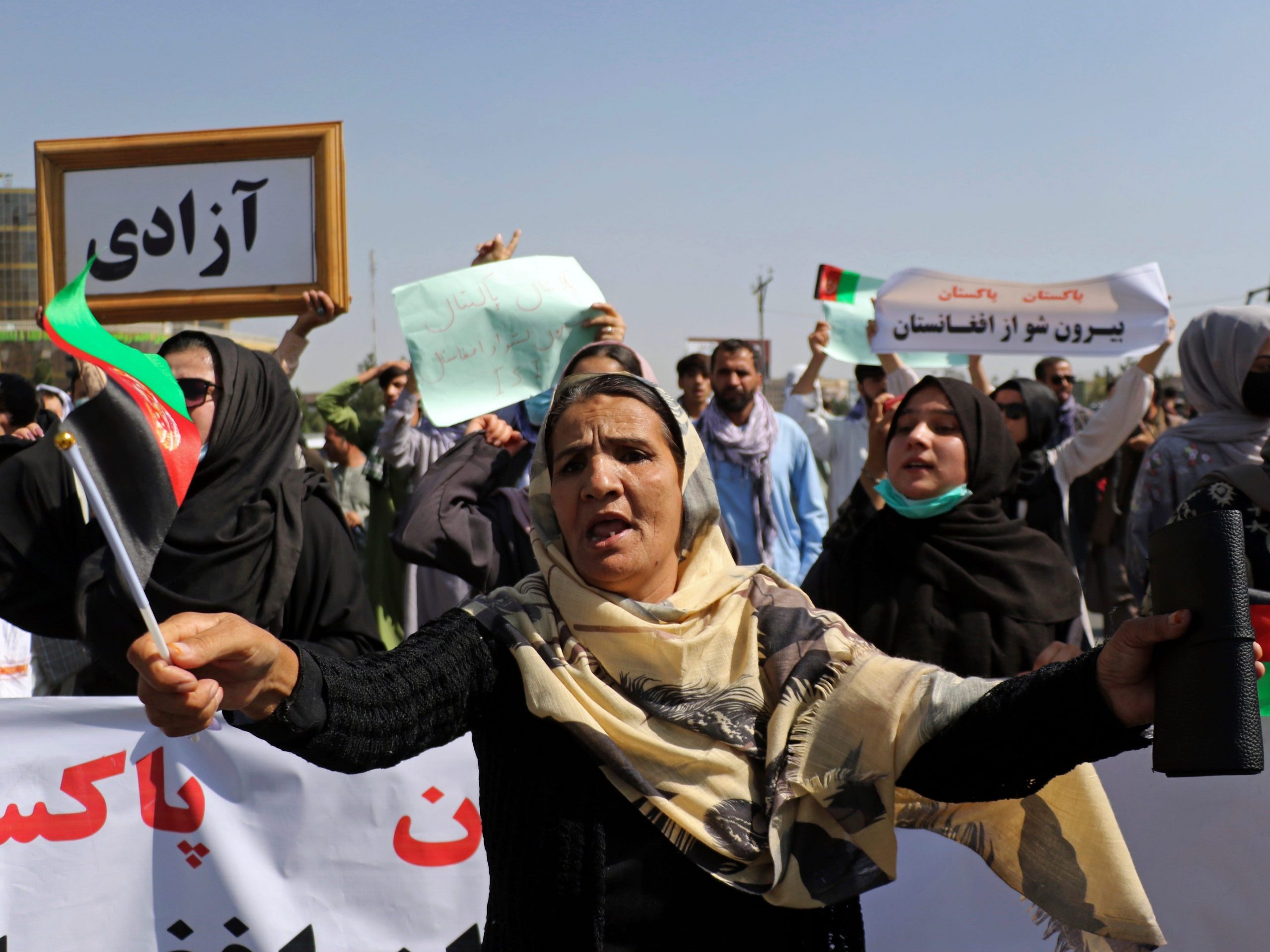 Afghan women shout slogans during an anti-Pakistan demonstration, near the Pakistan embassy in Kabul, Afghanistan, Tuesday, Sept. 7, 2021. The framed sign in Persian reads, "Freedom."