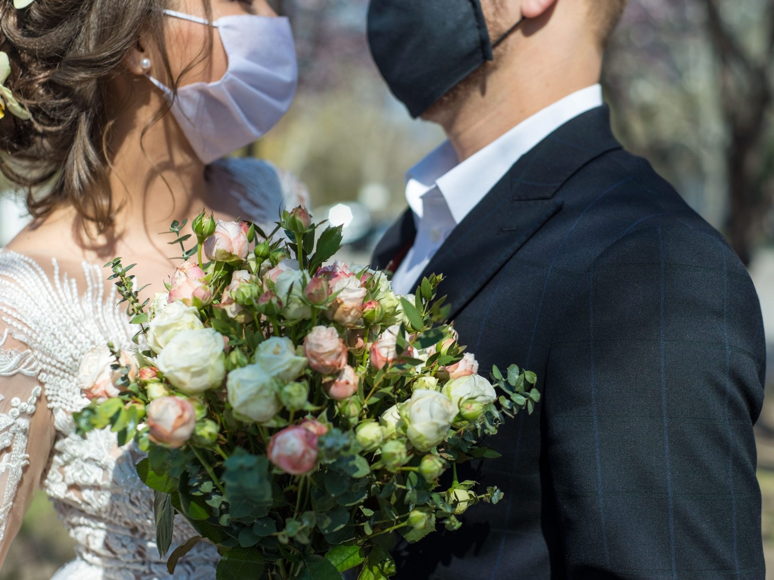 couple with masks on getting married