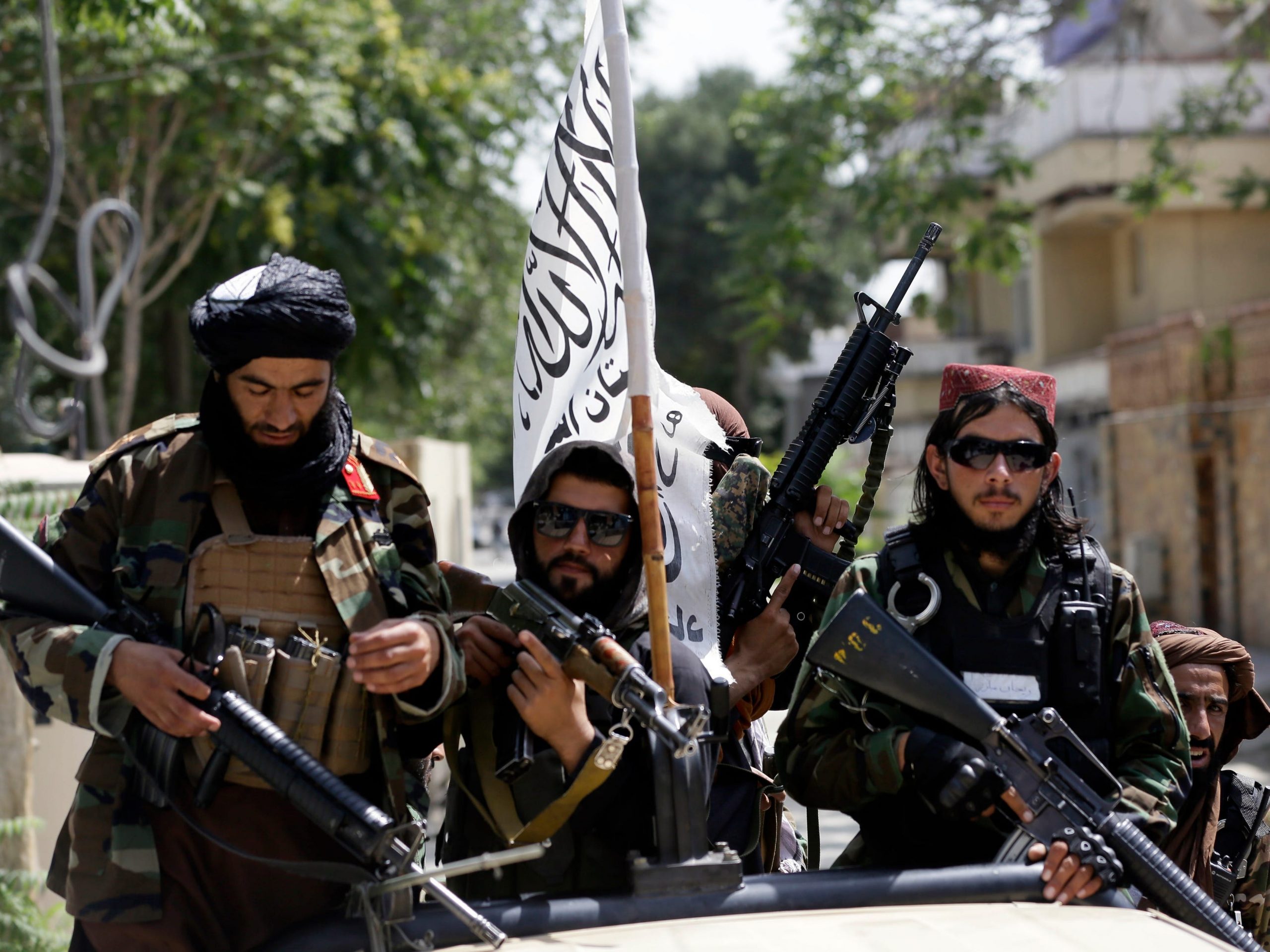 Taliban fighters display their flag on patrol in Kabul, Afghanistan, Thursday, Aug. 19, 2021.