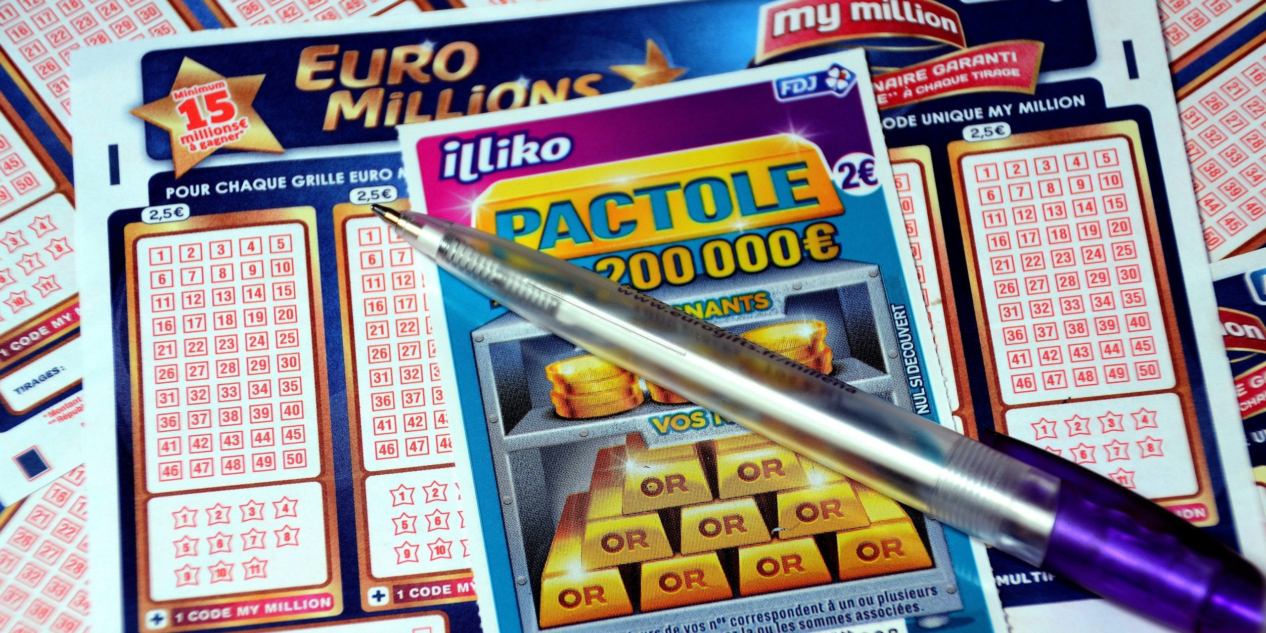 In this photo illustration is a pen and a scratch card on Euromillions tickets.