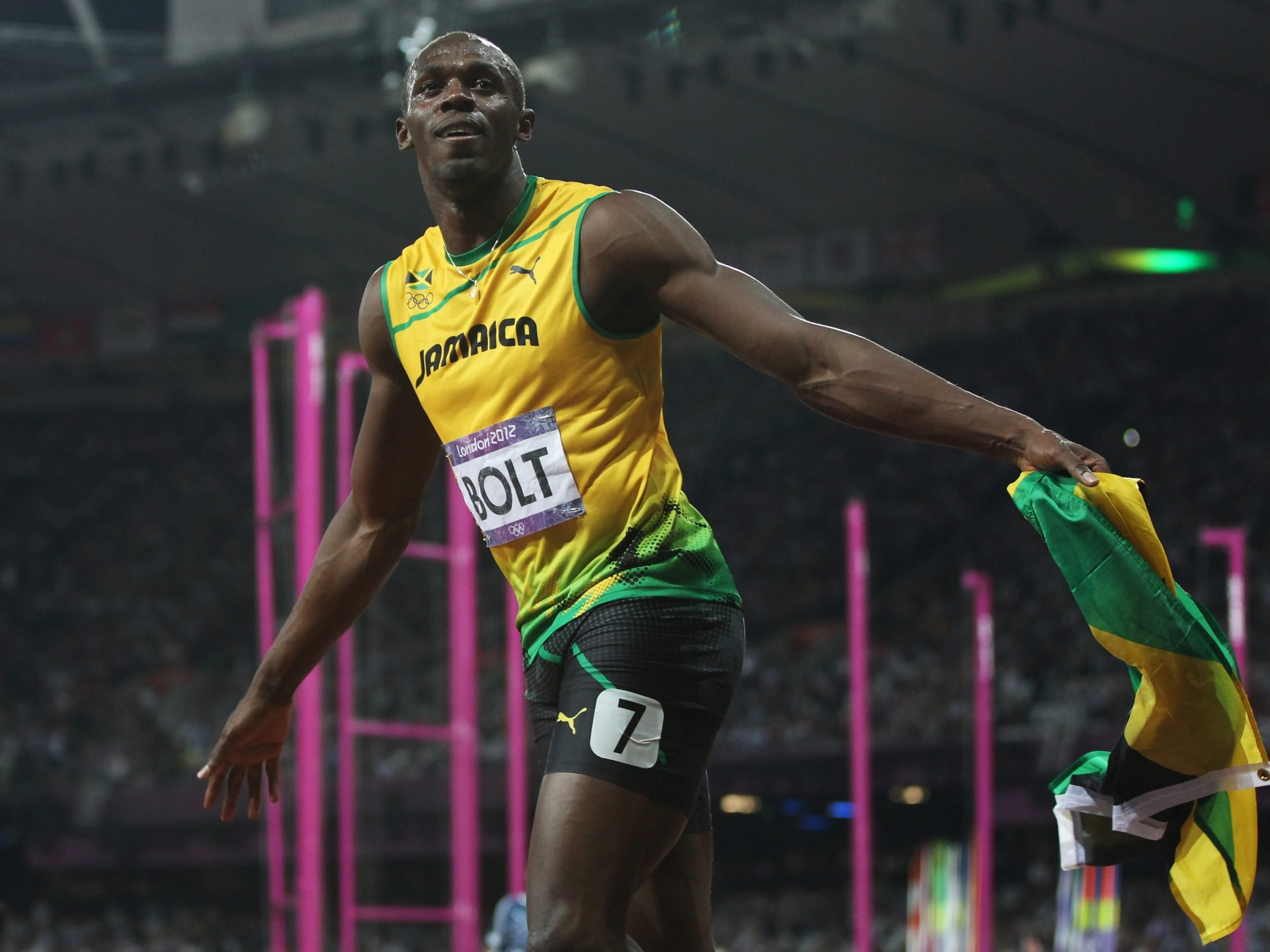 Usain Bolt celebrates after he wins gold during the Men's 200m Final on Day 13 of the London 2012 Olympic Games