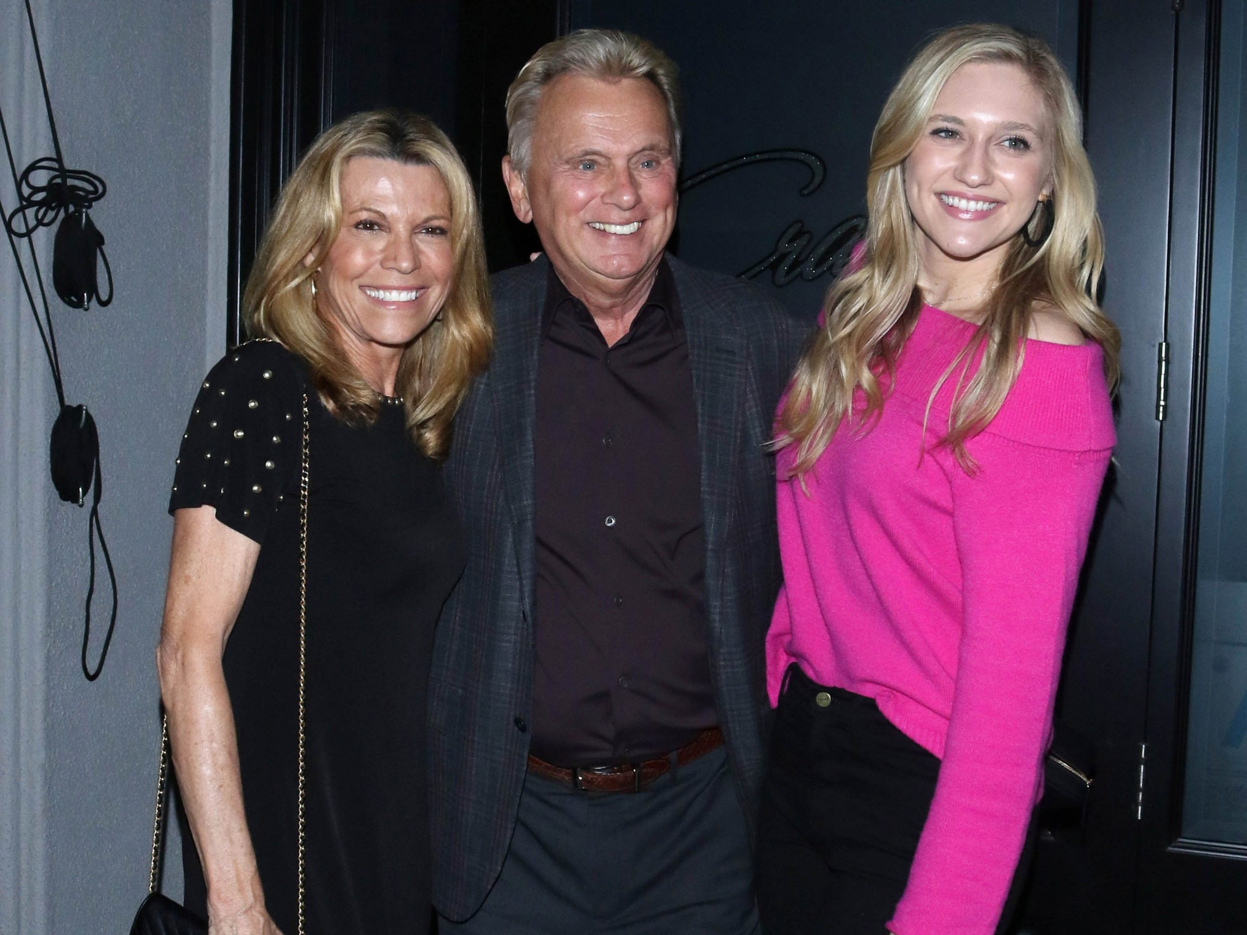 Vanna White, Pat Sajak, and Maggie Sajak pose and smile