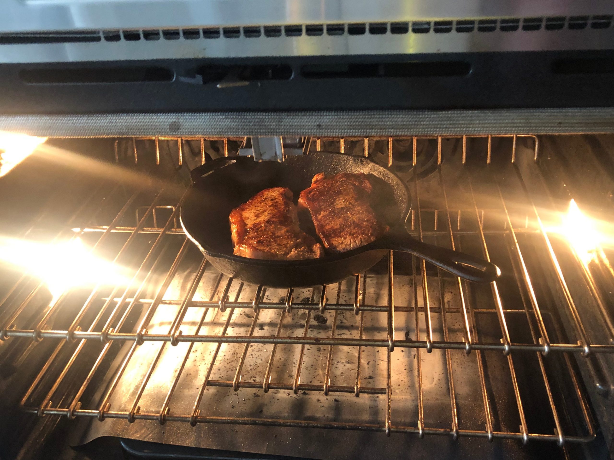 Two steaks in an oven.