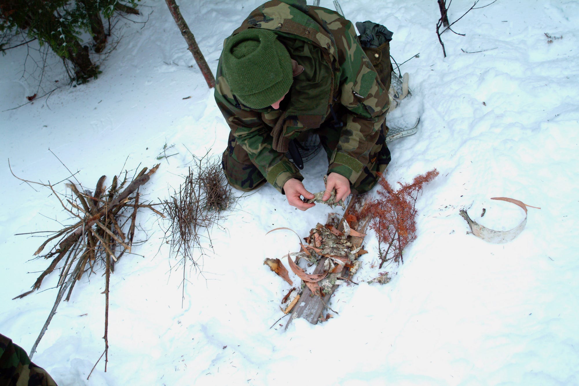 Navy survival, evasion, resistance and escape SERE student starts fire