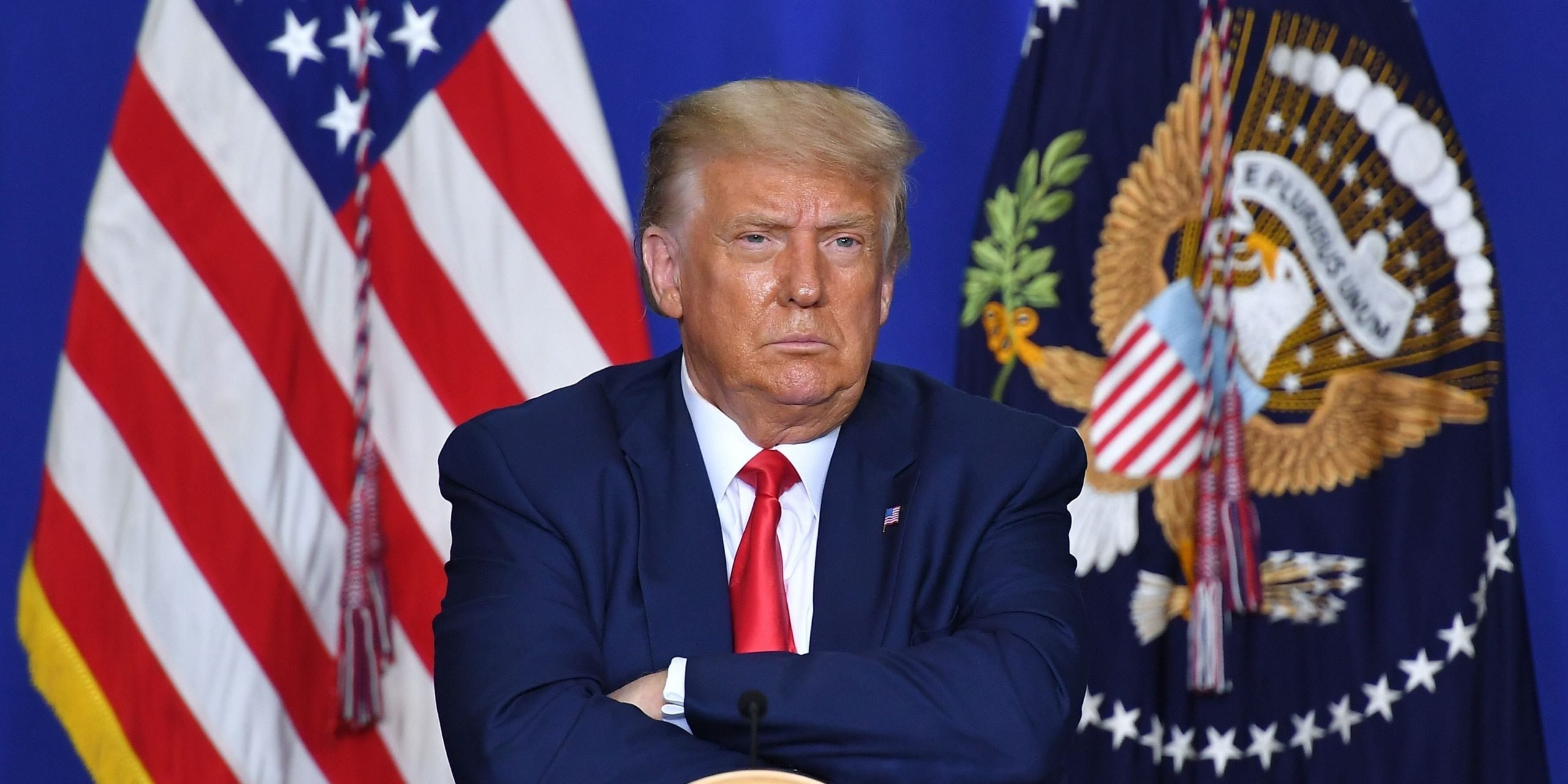 US President Donald Trump listens to officials during a roundtable discussion on community safety, at Mary D. Bradford High School in in Kenosha, Wisconsin on September 1, 2020. - Trump said Tuesday on a visit to protest-hit Kenosha, Wisconsin that recent anti-police demonstrations in the city were acts of "domestic terror" committed by violent mobs. "These are not acts of peaceful protest but really domestic terror," Trump said, describing multiple nights of angry demonstrations last week after a white police officer in Kenosha shot a black man in the back at close range.