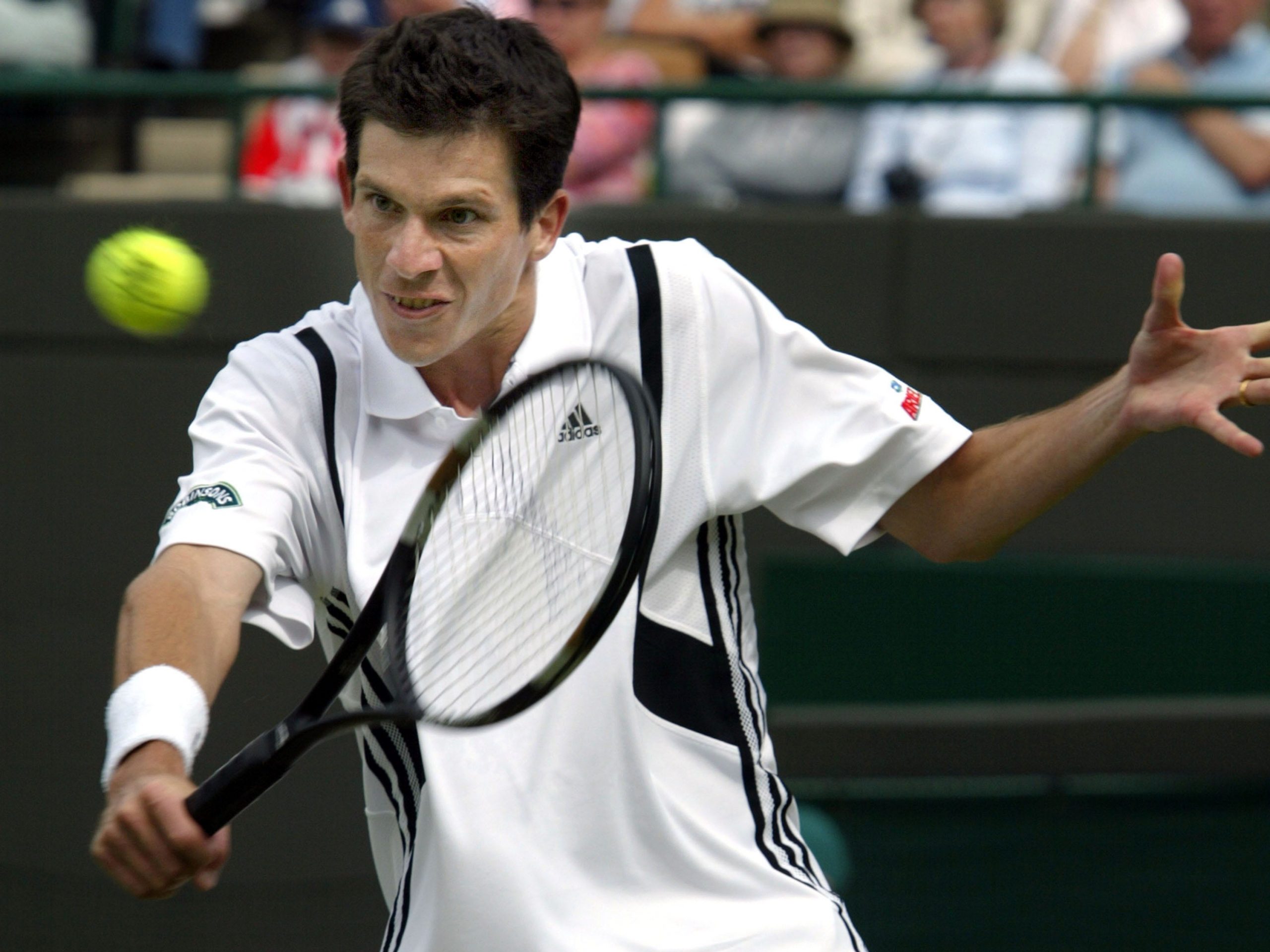 Tim Henman plays a shot at Wimbledon