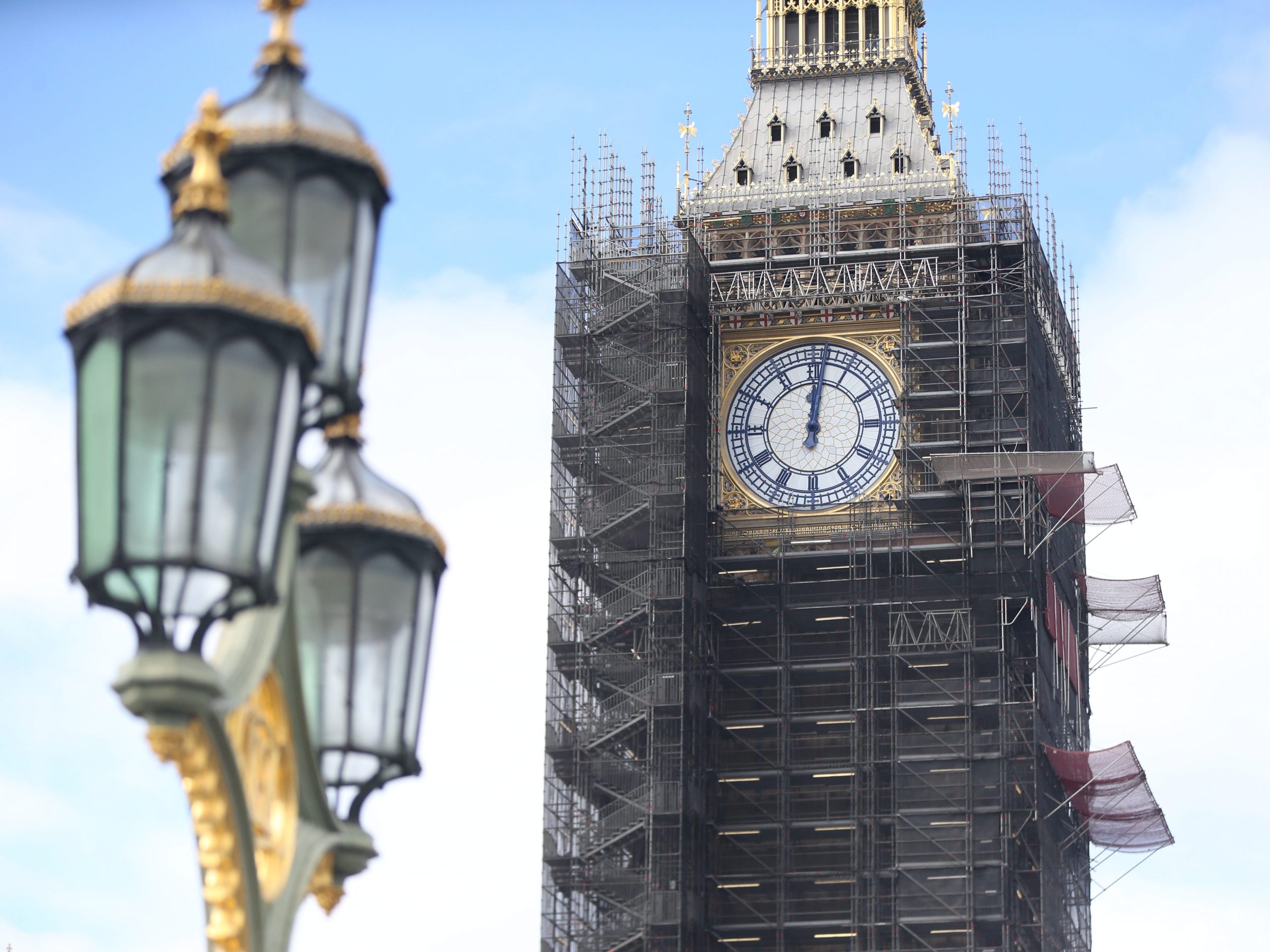 A photo shows the restored clock face on Elizabeth Tower, displaying the original Prussian blue color of the hands, on September 10, 2021 in London, United Kingdom. 96-metre-tall Elizabeth Tower also known as Big Ben, has been under restoration work since 2017 as it was discovered that its clock hands were originally blue instead of black.