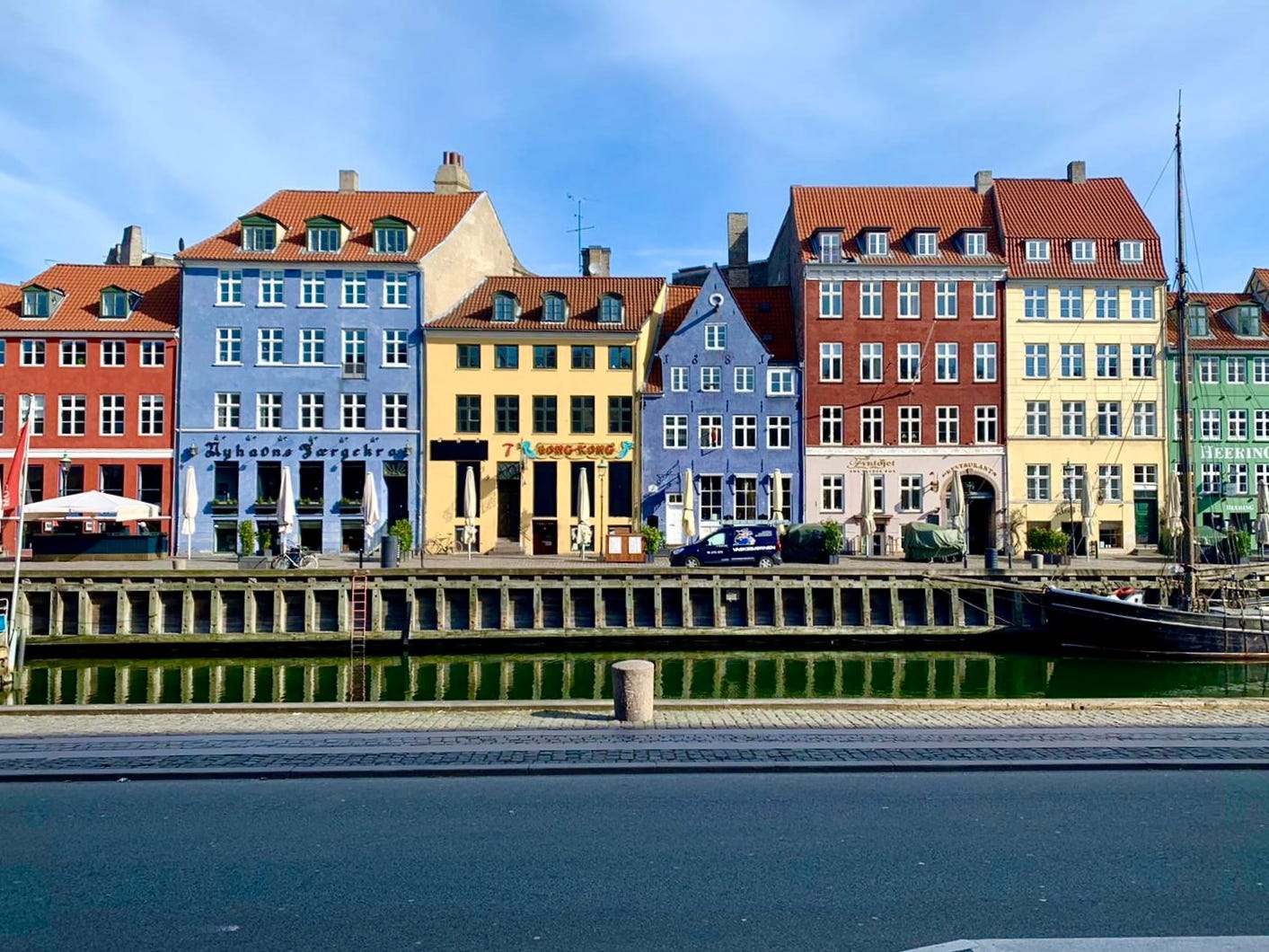 Colorful buildings line the sides of harbors in Copenhagen, Denmark.