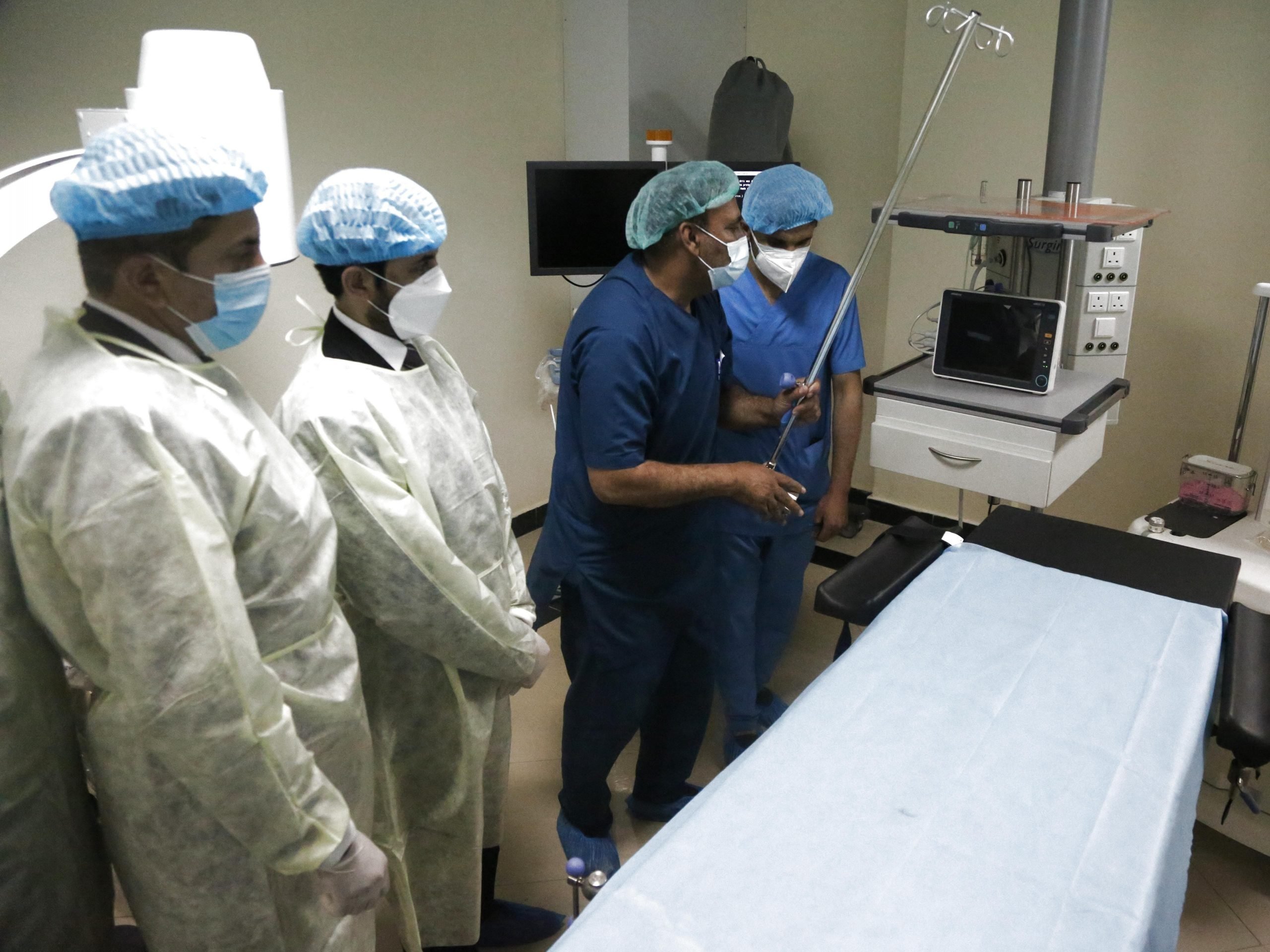 Group of doctors in scrubs look at a hospital in Kabul, Afghanistan