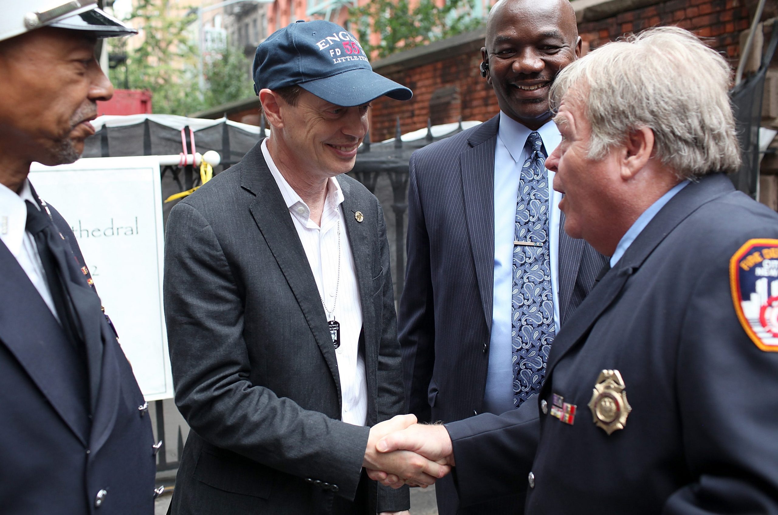 Actor and former FDNY firefighter Steve Buscemi greets firefighters after a memorial service at Old St. Pat's Church to mark the tenth anniversary of the September 11 terror attacks.