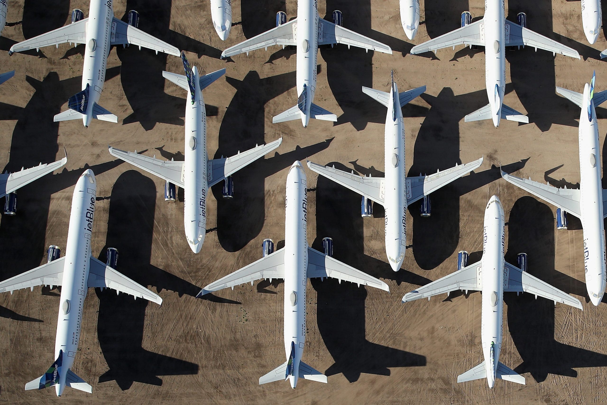 JetBlue planes are seen from above on a tarmac in Arizona in an interlocked pattern