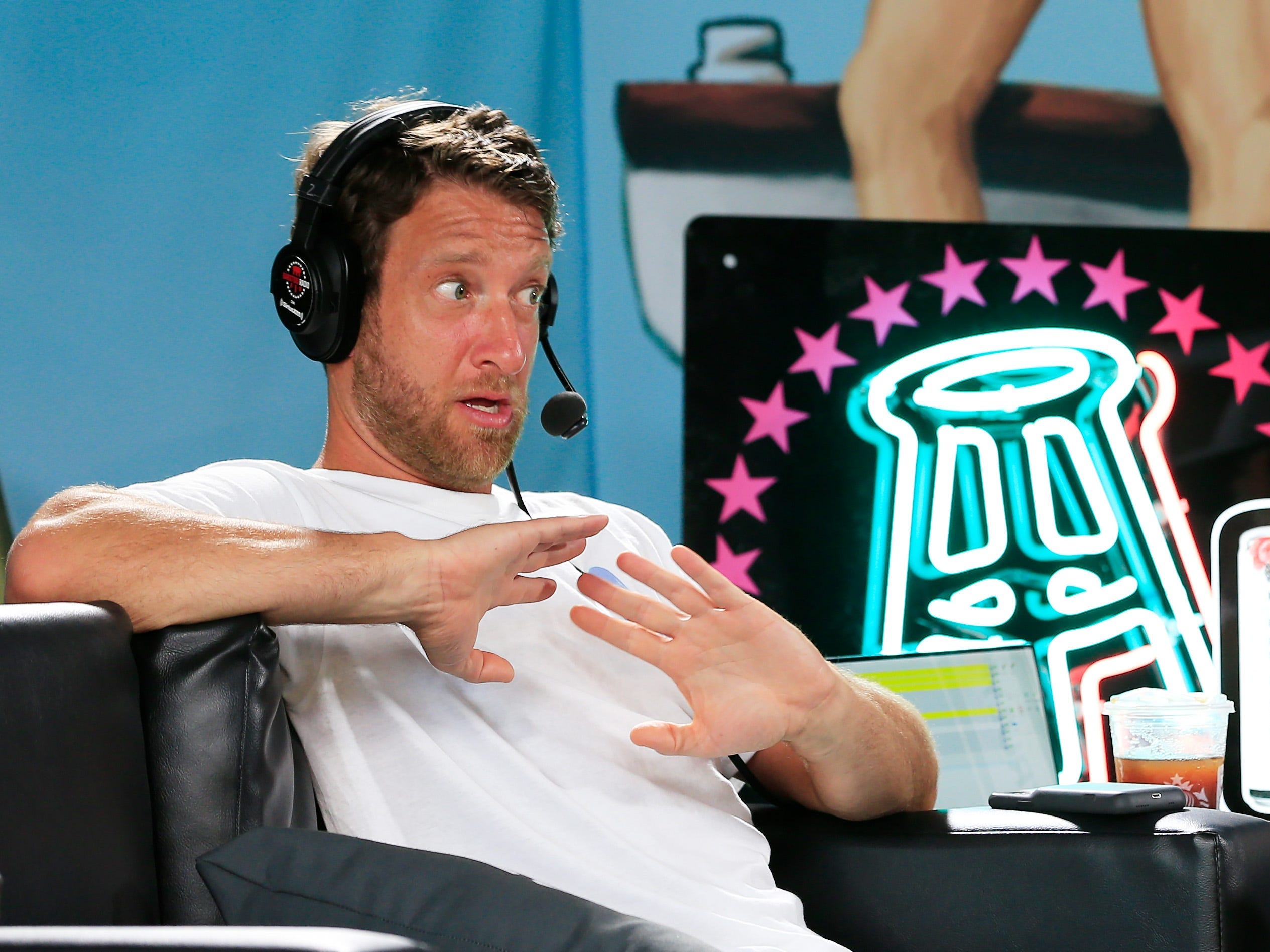 Barstool Sports' founder Dave Portnoy speaks in front of a Barstool logo during a radio broadcast in Miami Beach, Florida on January 30, 2020.
