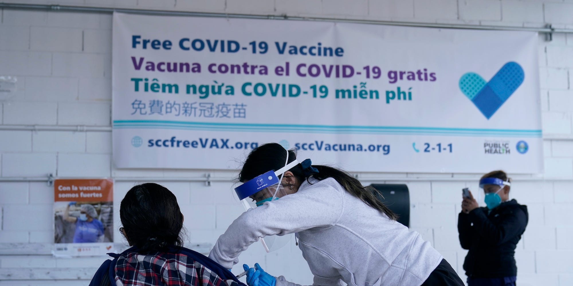 In this March 3, 2021, file photo, a member of the National Guard, center, administers the Moderna COVID-19 vaccine to a farmworker at a County of Santa Clara mobile vaccination clinic at Monterey Mushrooms, an agricultural employer under the United Farm Workers union contract, in Morgan Hill, Calif.