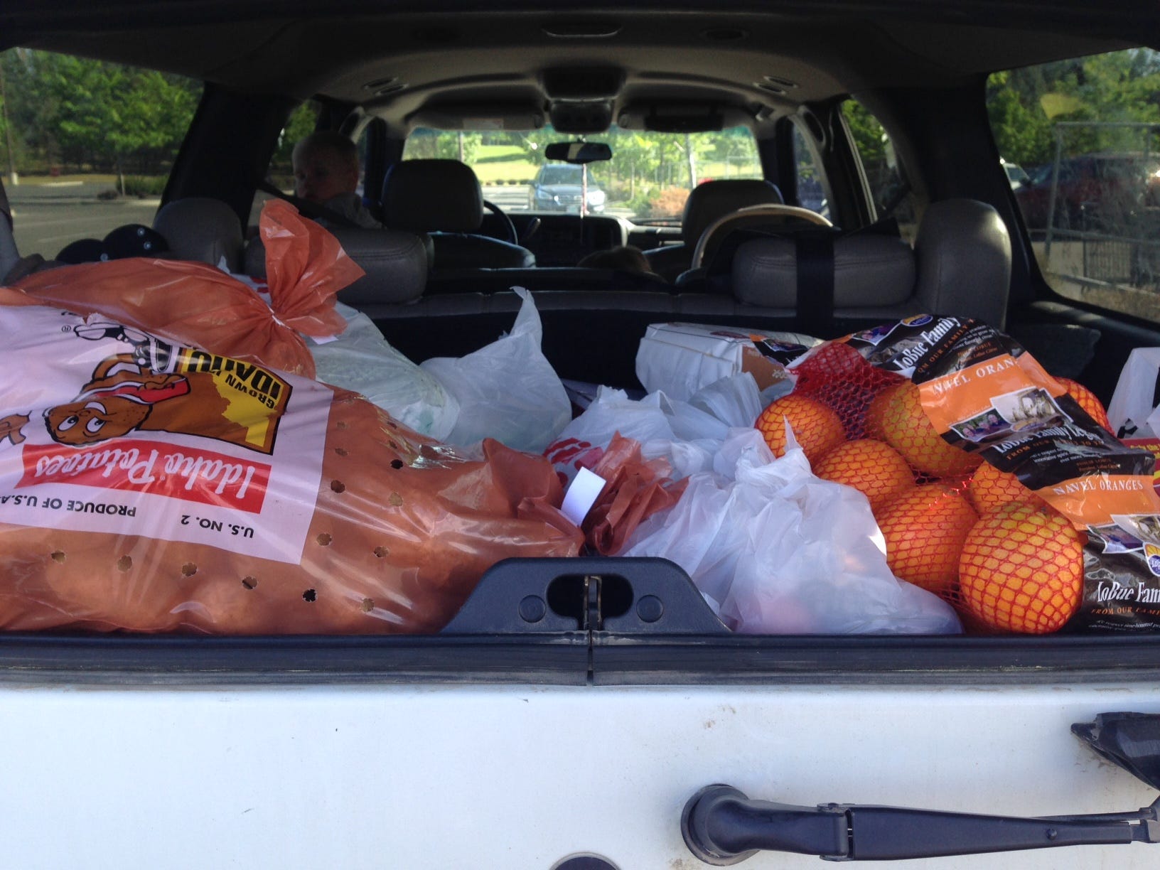 truck of an suv filled with groceries and food