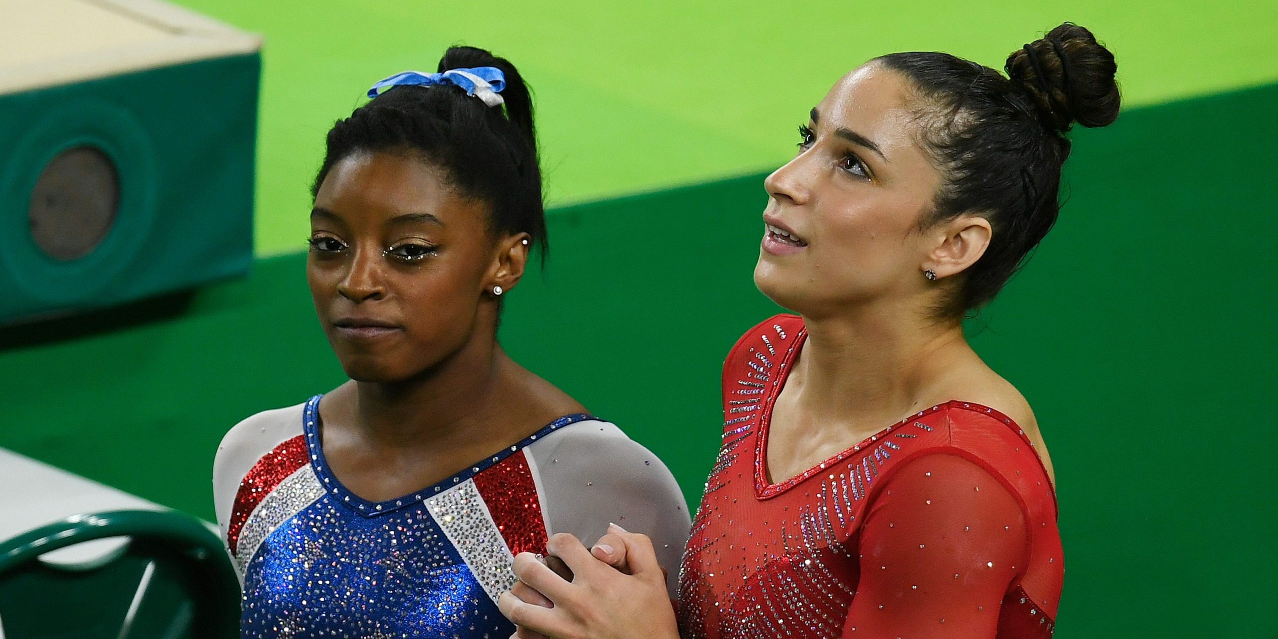 Simone Biles (left) and Aly Raisman walk hand in hand before their final event, the floor routine, before capturing the gold (Biles) and silver (Raisman) during the women's individual all-around at Rio 2016 on Thursday, August 11, 2016.