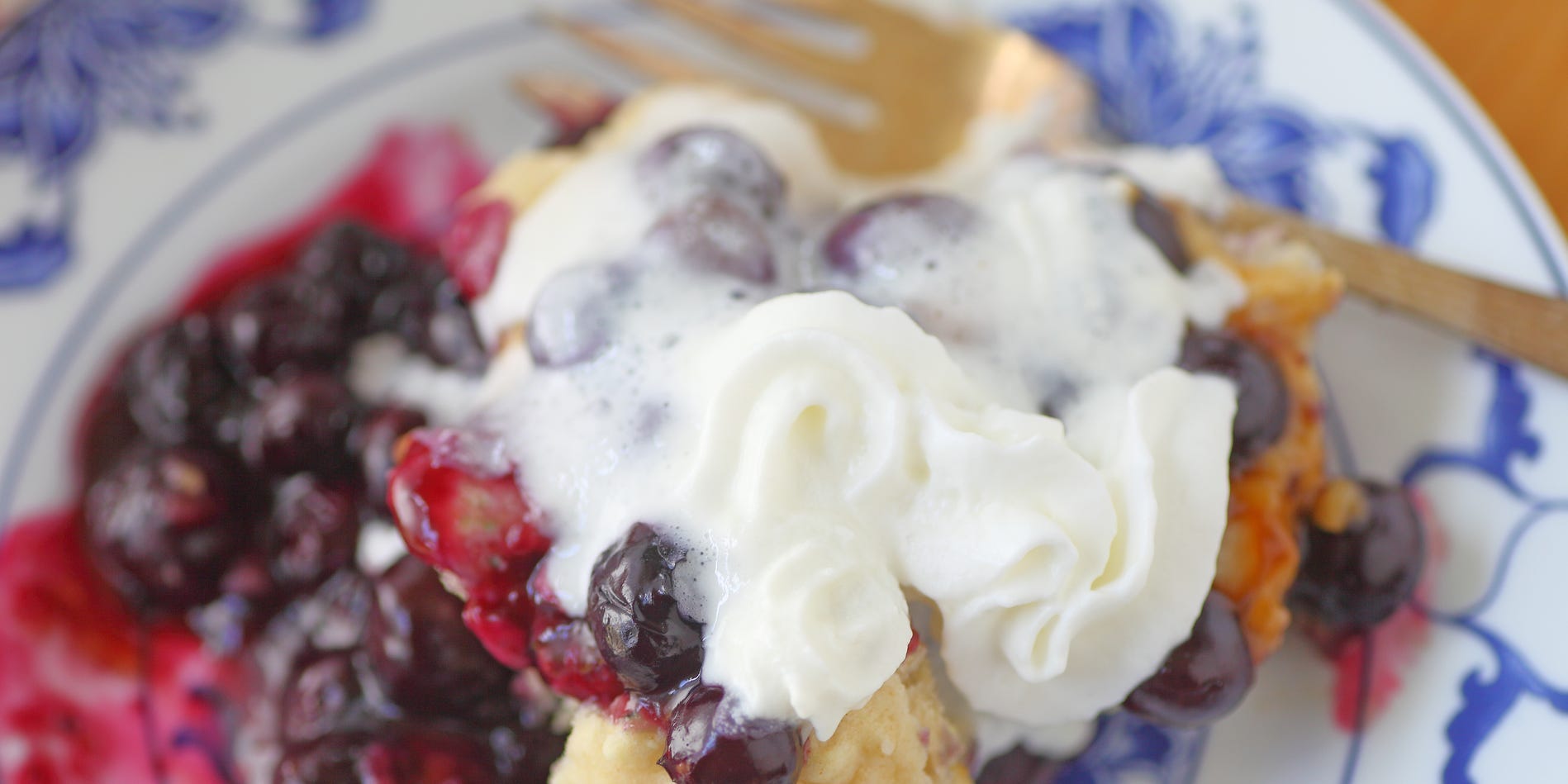 Blueberry cobbler topped with whipped cream.