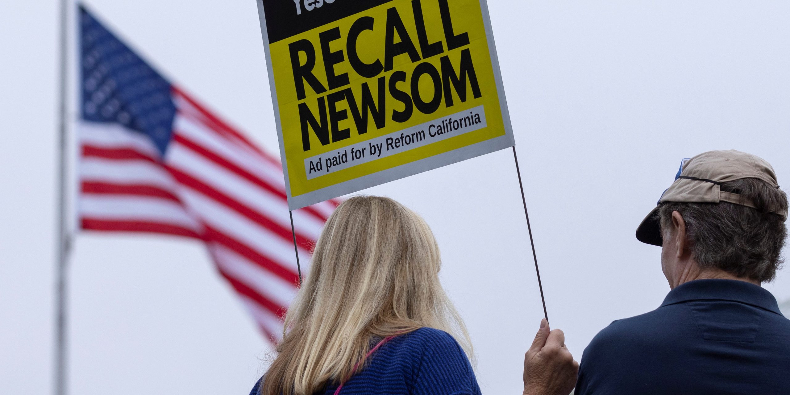 Supporters of the recall campaign of California governor Gavin Newsom holding a sign