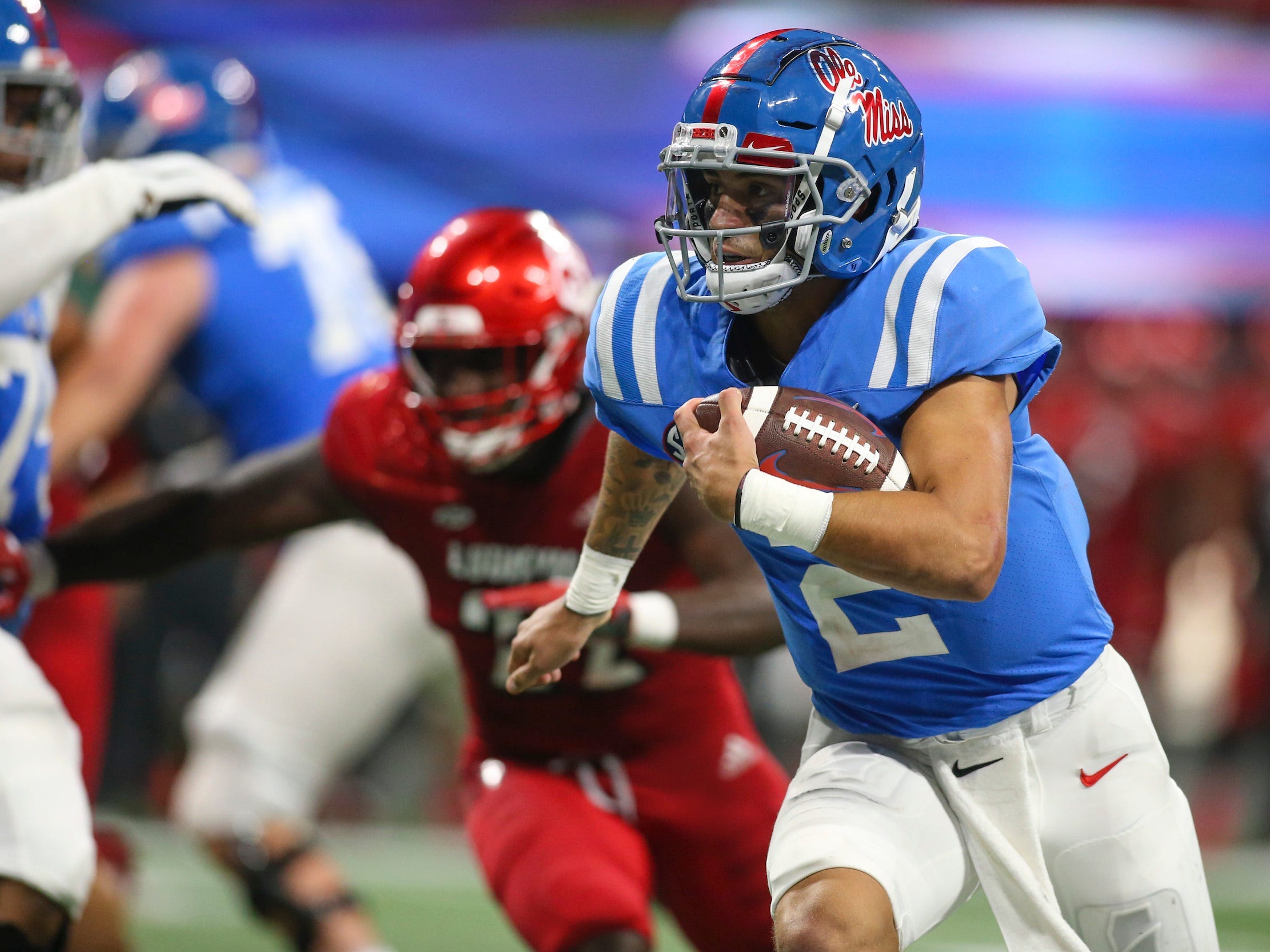 Ole Miss quarterback Matt Corral runs the ball against the Louisville Cardinals.