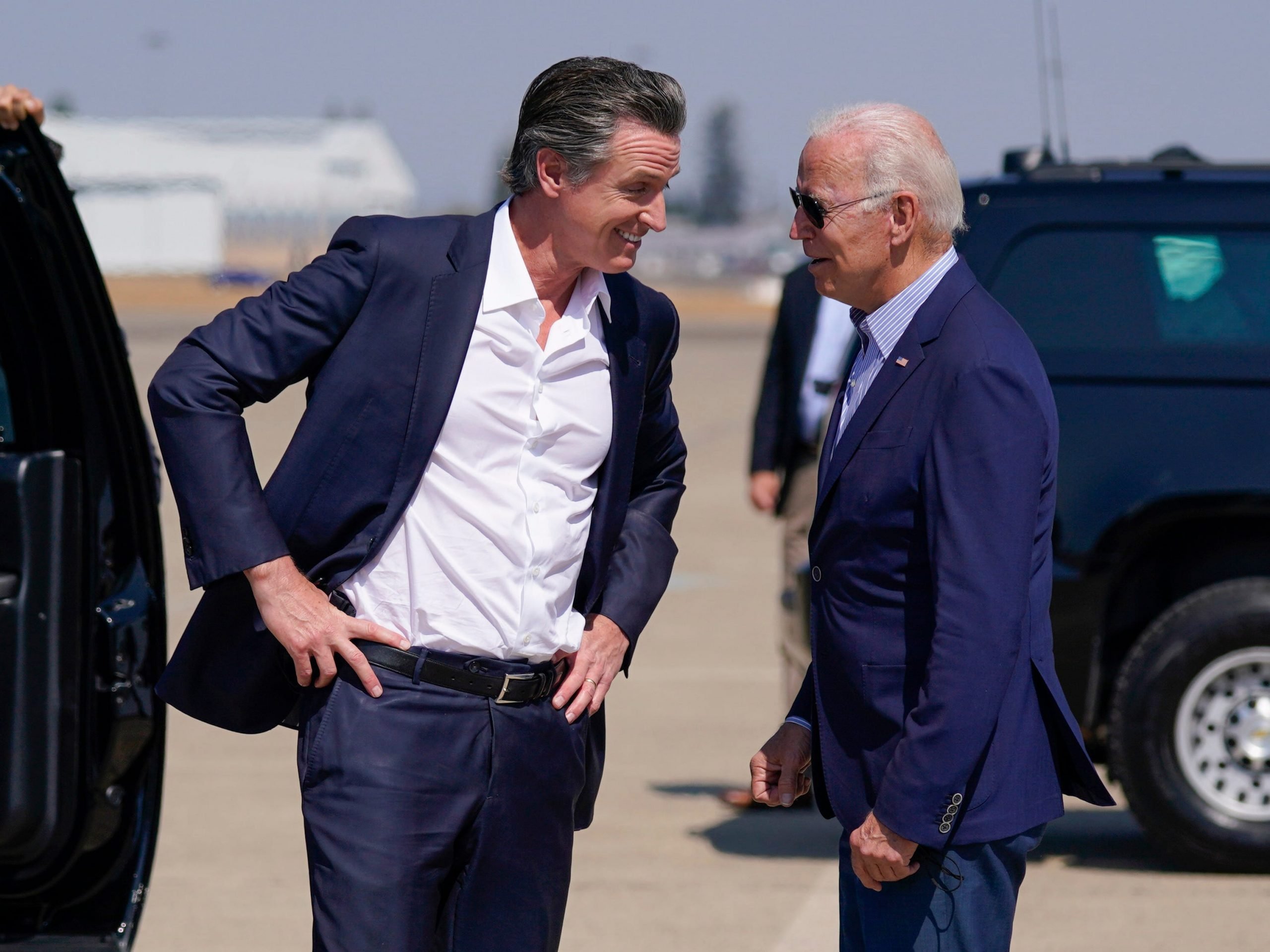 President Joe Biden talks with California Gov. Gavin Newsom as he arrives at Mather Airport on Air Force One Monday, Sept. 13, 2021, in Mather, Calif., for a briefing on wildfires at the California Governor's Office of Emergency Services.