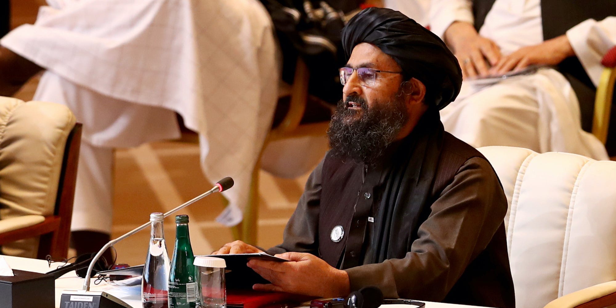 Mullah Abdul Ghani Baradar sitting at a conference table in September 2021.