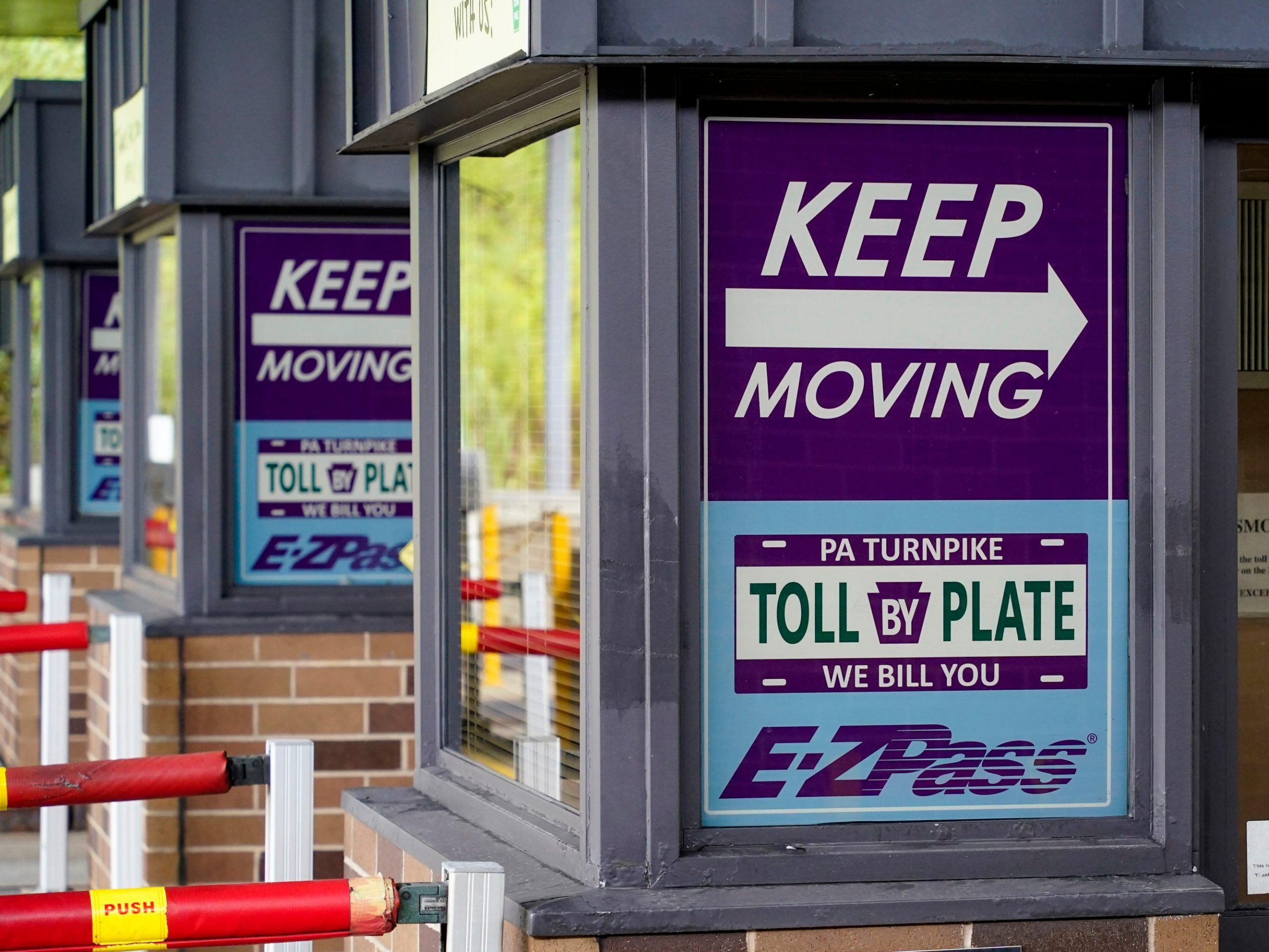 Signs on the electronic toll booths indicate to motorists entering the Pennsylvania Turnpike in Gibsonia, Pa. on Monday, Aug. 30, 2021, to keep moving and the methods being used to collect tolls. More than $104 million in Pennsylvania Turnpike tolls went uncollected last year as the agency fully converted to all-electronic tolling. Turnpike records show the millions of motorists who don’t use E-ZPass have a nearly 1 in 2 chance of riding without paying under the “toll-by-plate” license plate reader system.